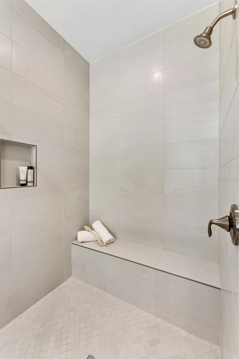Spacious Walk In Shower With Bench Seating at Primary Ensuite