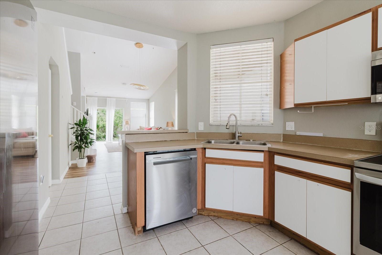 Eat In Kitchen With Tile Floors and Stainless Steel Appliances, And The Washer & Dryer Are In The Kitchen - Overlooks Into The Living Room 2