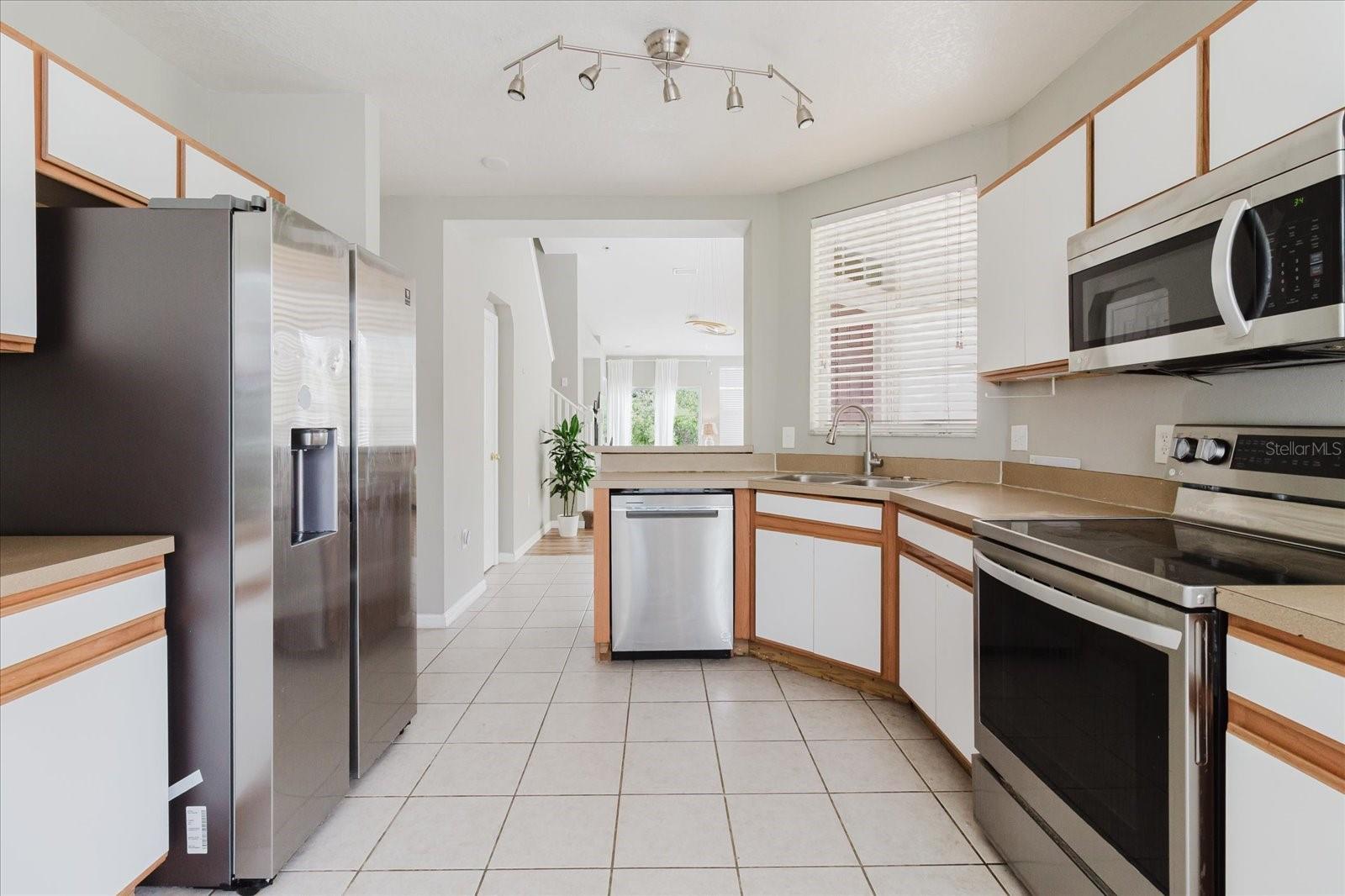 Eat In Kitchen With Tile Floors and Stainless Steel Appliances, And The Washer & Dryer Are In The Kitchen - Overlooks Into The Living Room 5