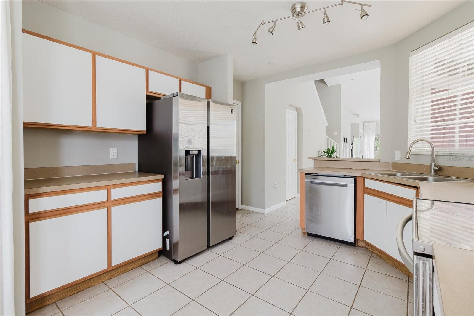 Eat In Kitchen With Tile Floors and Stainless Steel Appliances, And The Washer & Dryer Are In The Kitchen - Overlooks Into The Living Room 6