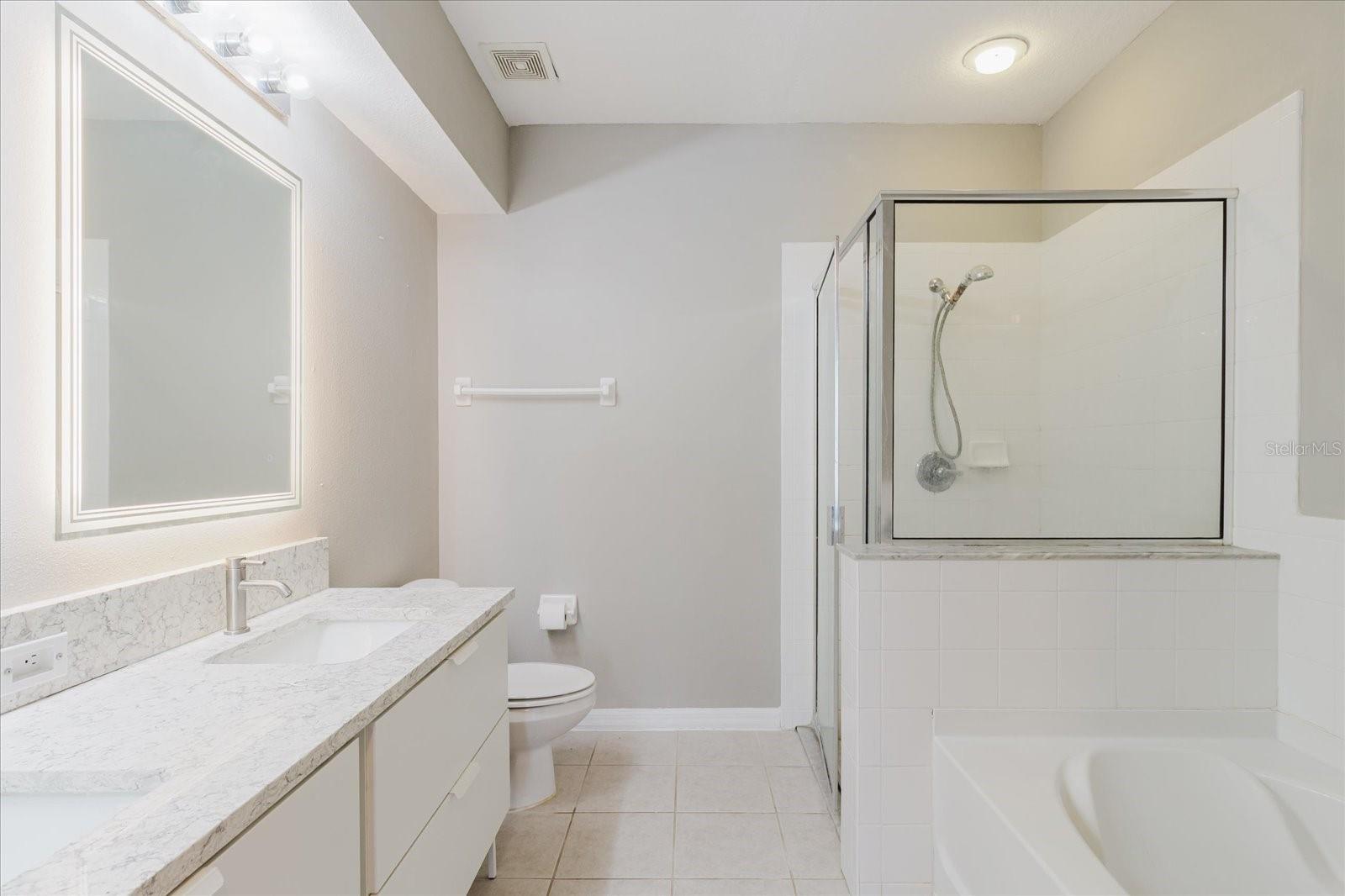 Full En Suite Bath With Dual Vanities, Walk In Shower, And A Separate Tub 1