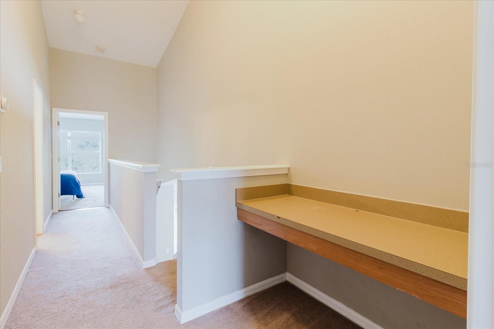 Loft With A Built In Desk At The Top Of The Stairs