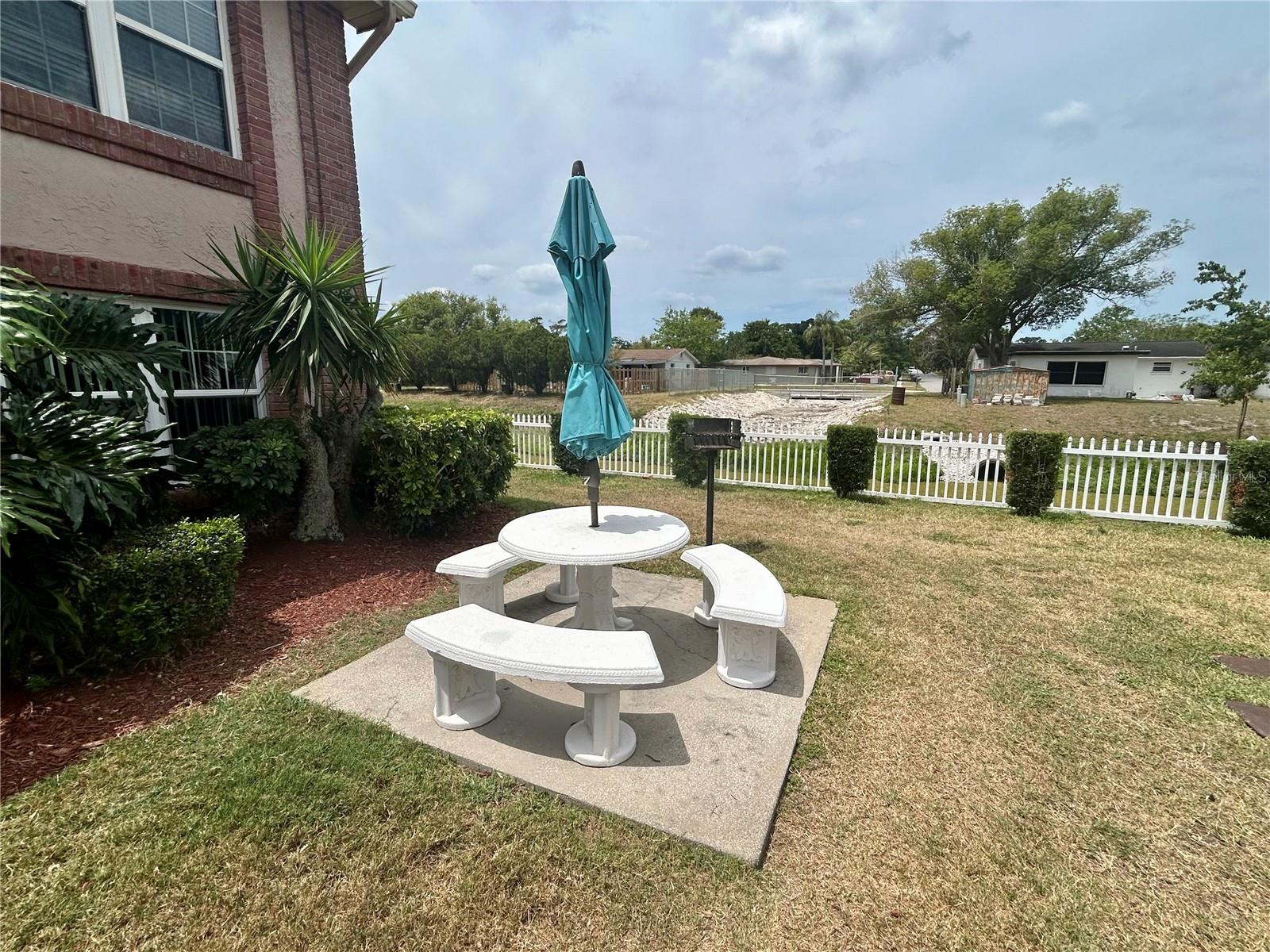 Table, umbrella and grill