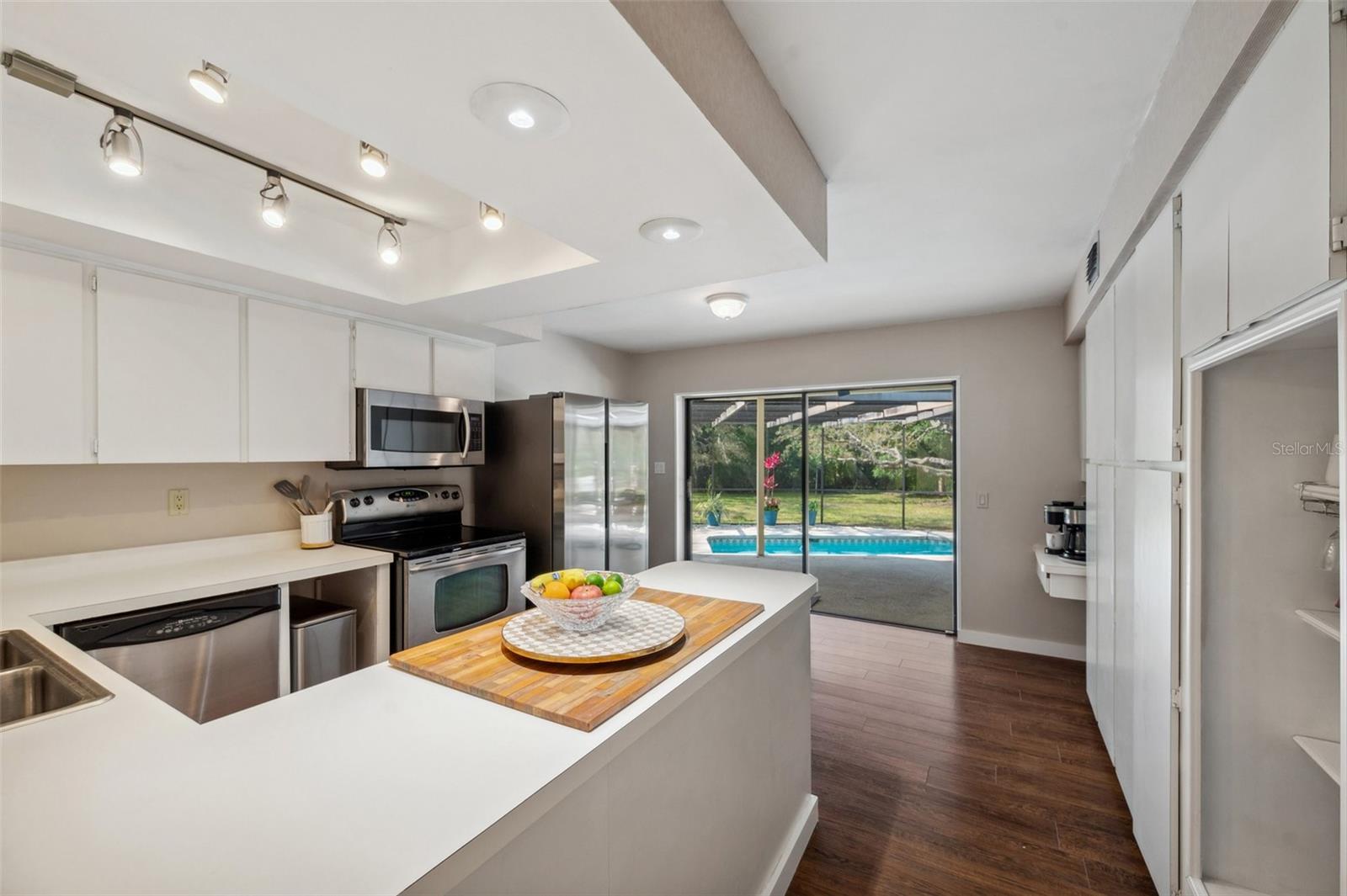 Kitchen overlooking pool and backyard