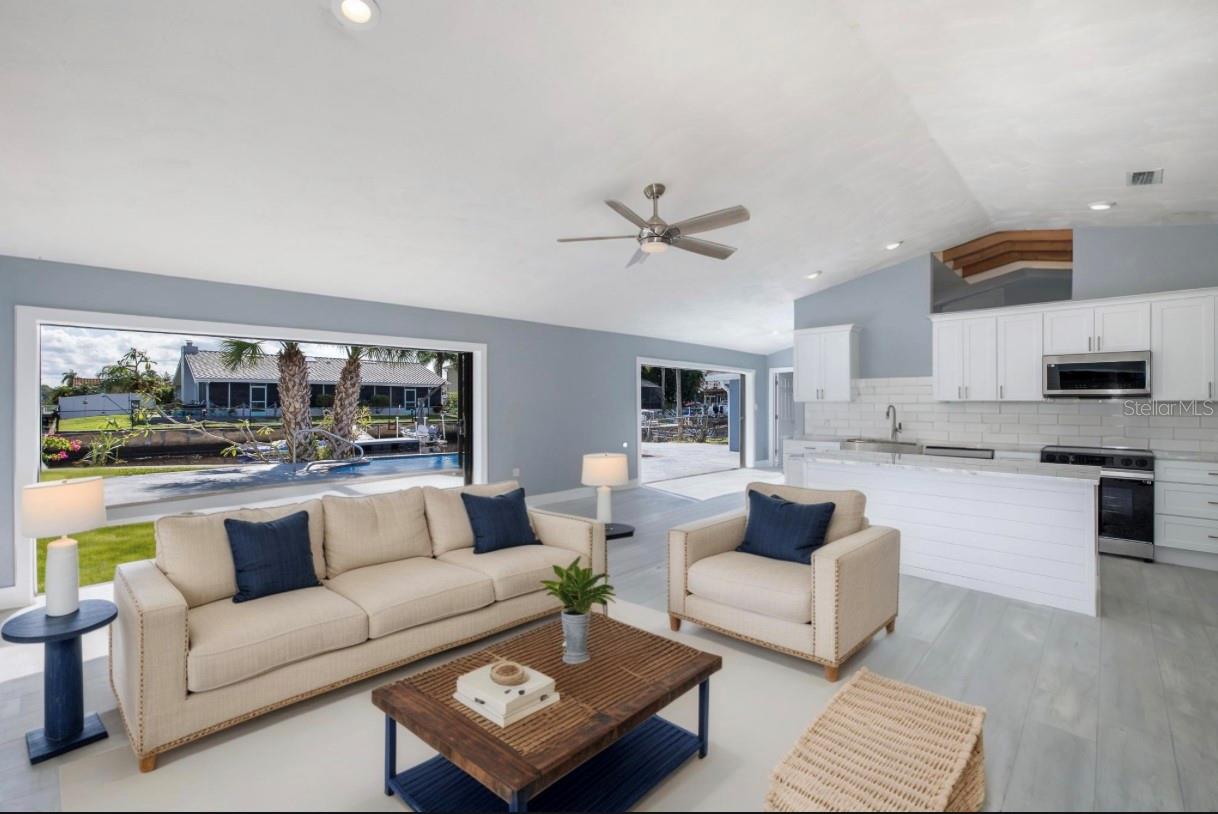 Great Room with pocketing sliding glass doors overlooking the kitchen