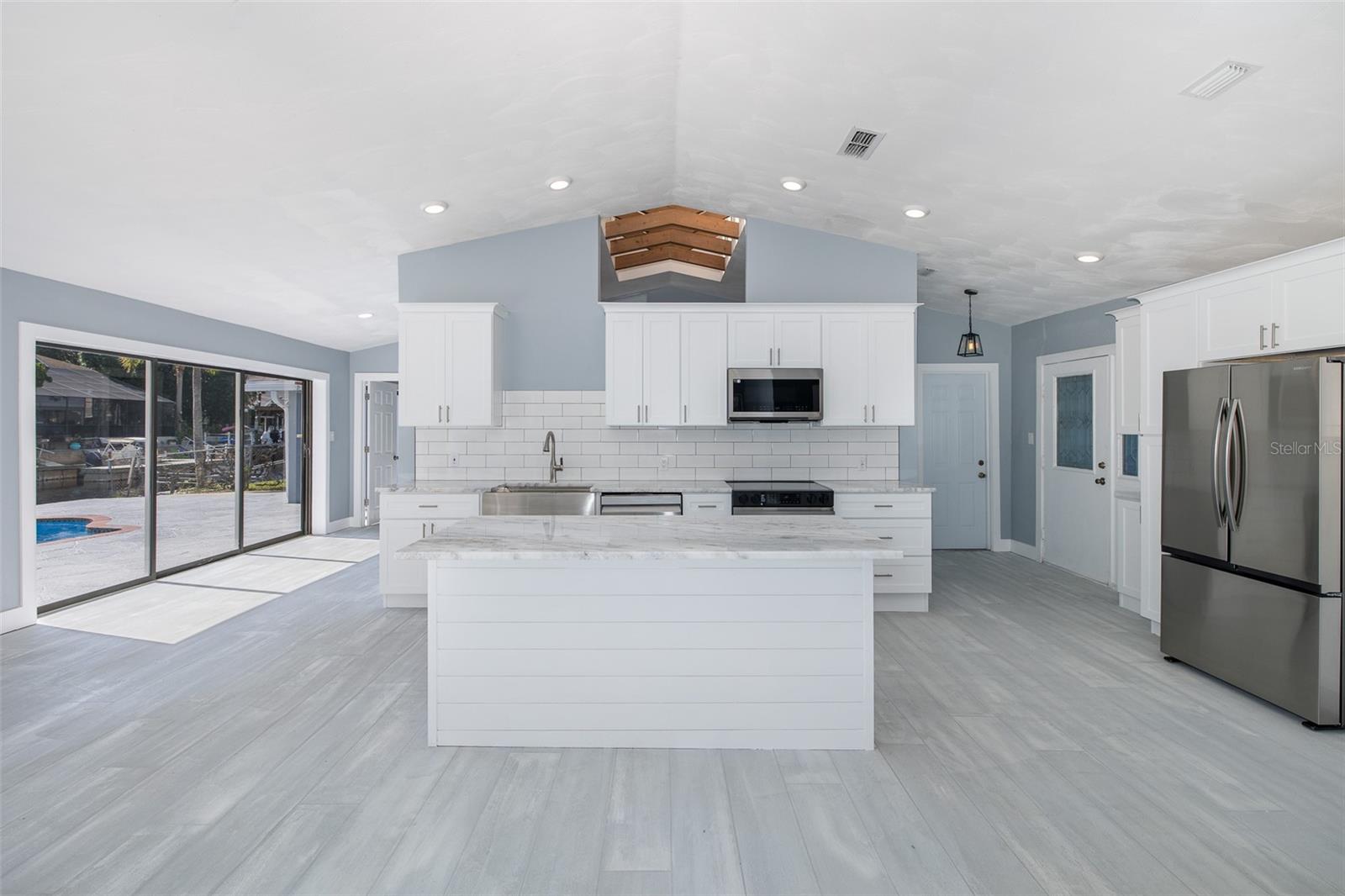 Spacious kitchen with center island overlooking the living space