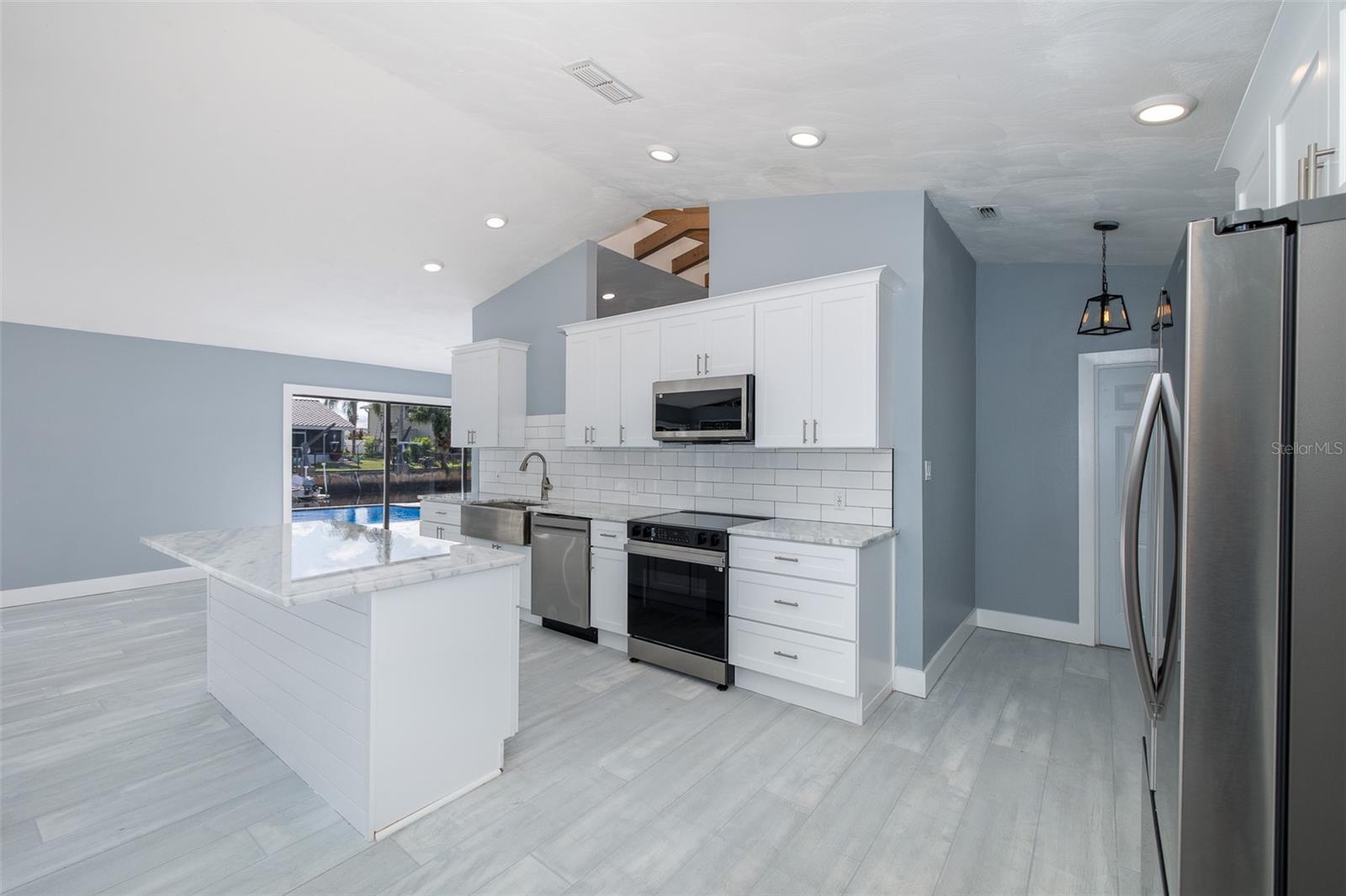 Spacious kitchen with center island overlooking the living space
