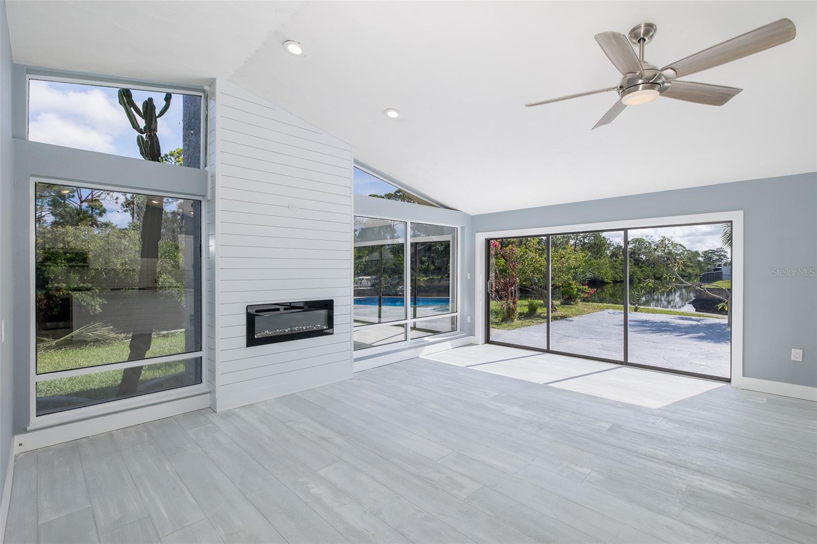 Wonderful Bright Great Room with Shiplap TV wall and fireplace