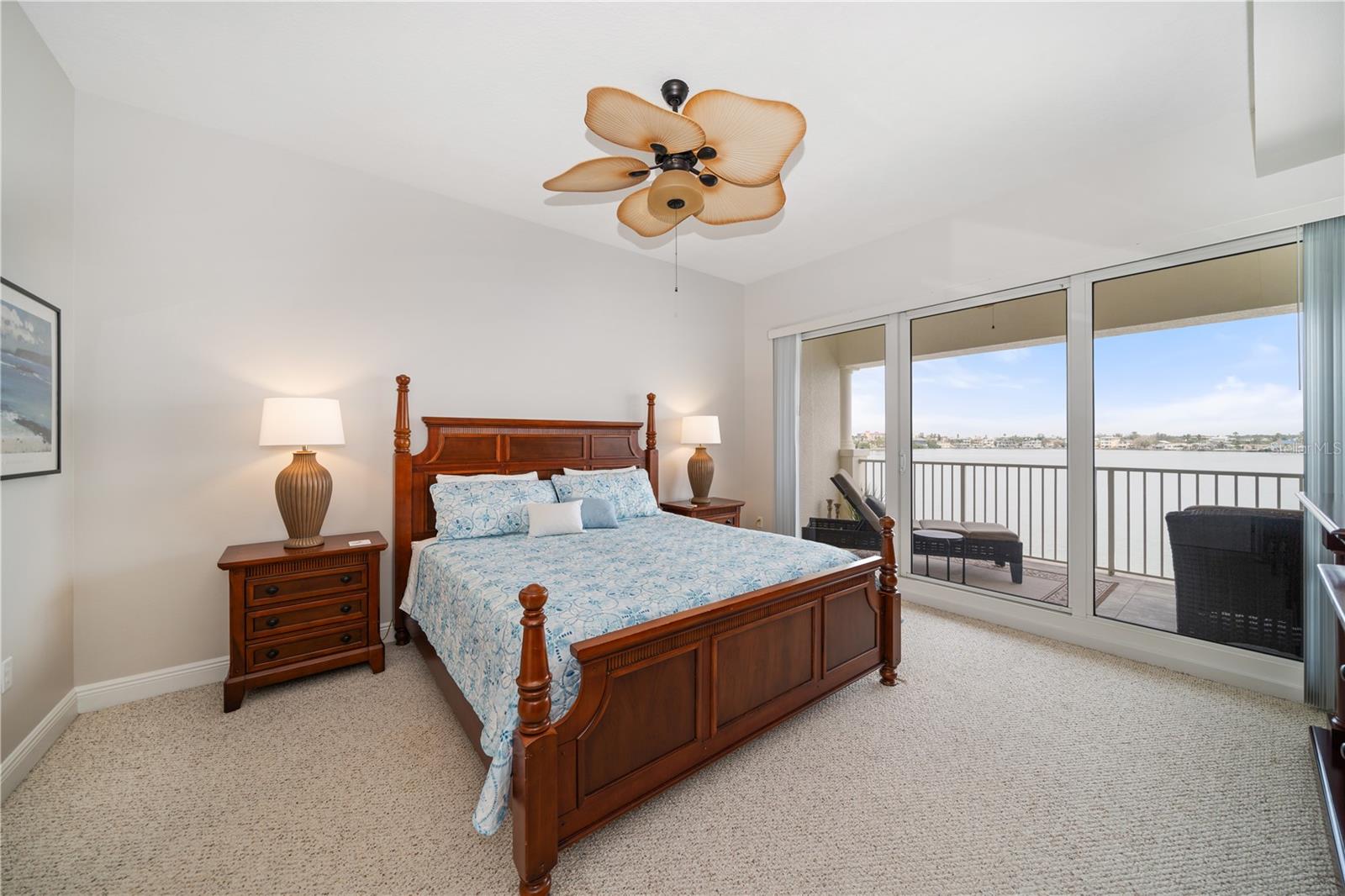 Primary en-suite Bedroom #3 is off the back Waterside of the condo with 12x8 sliding glass doors to the balcony overlookingThe waterview, pool, and docks .