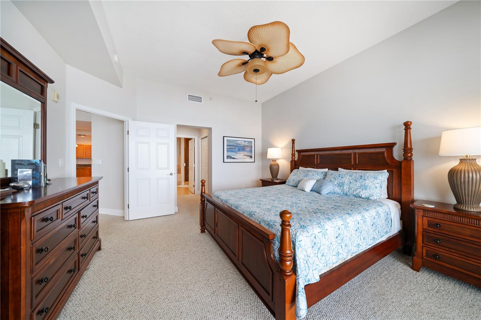 Primary bedroom view to his and hers walk in closets leading to full bathroom #3