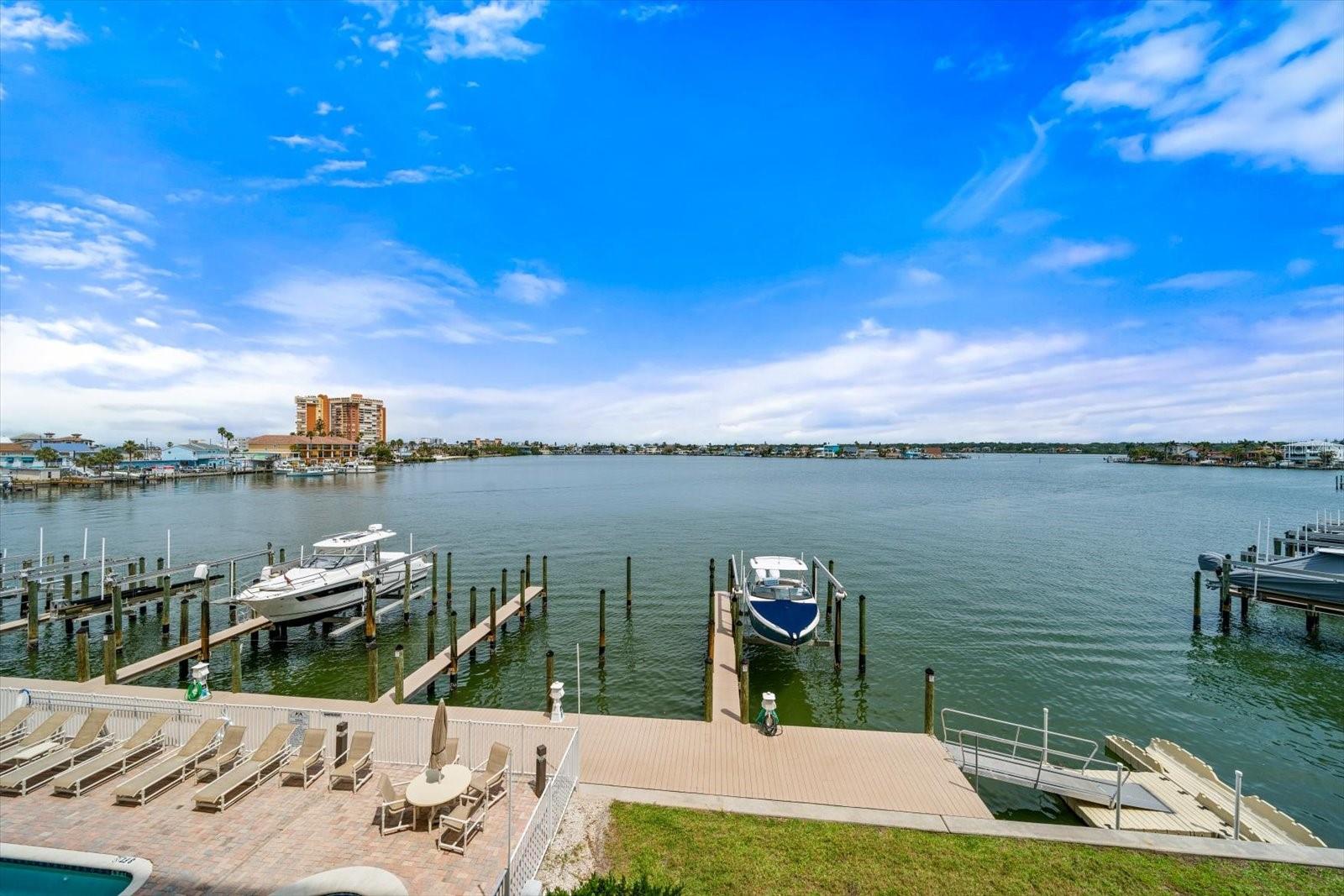 The exterior view from the 3rd floor condo shows the boat docks , pool area and has a nice grassy yard great for walks at night and enjoying fireworks during holidays !