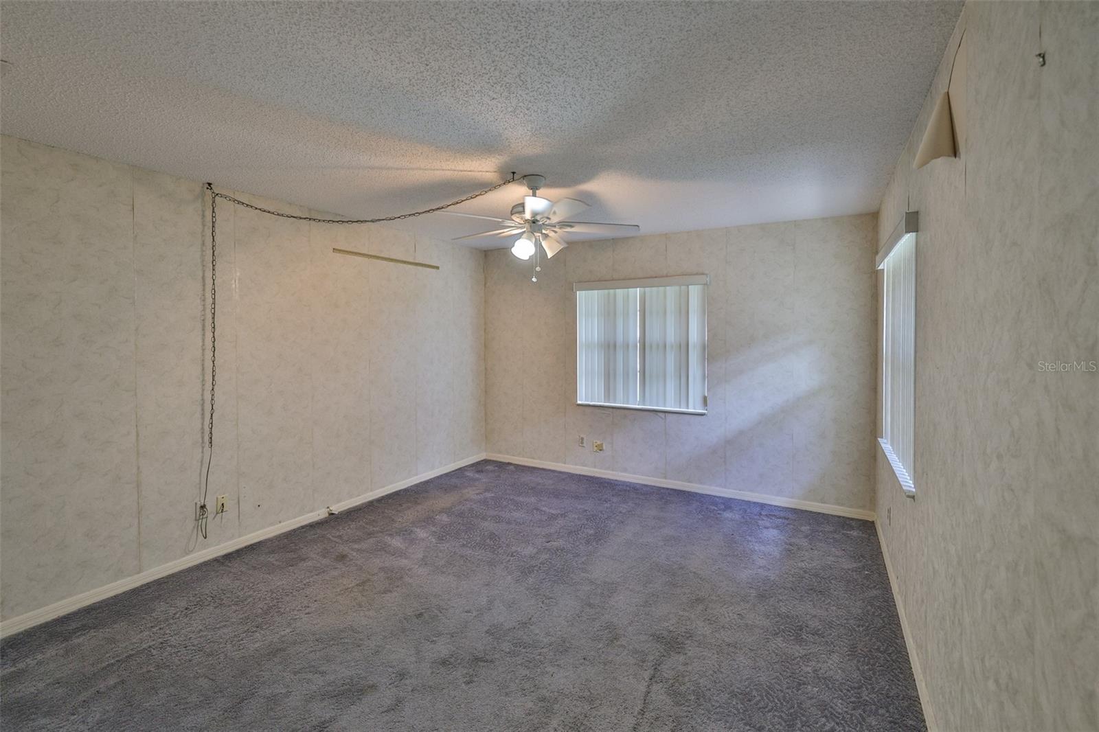 Bedroom 1 - Large with multiple windows and Florida sunshine filtering into the home.