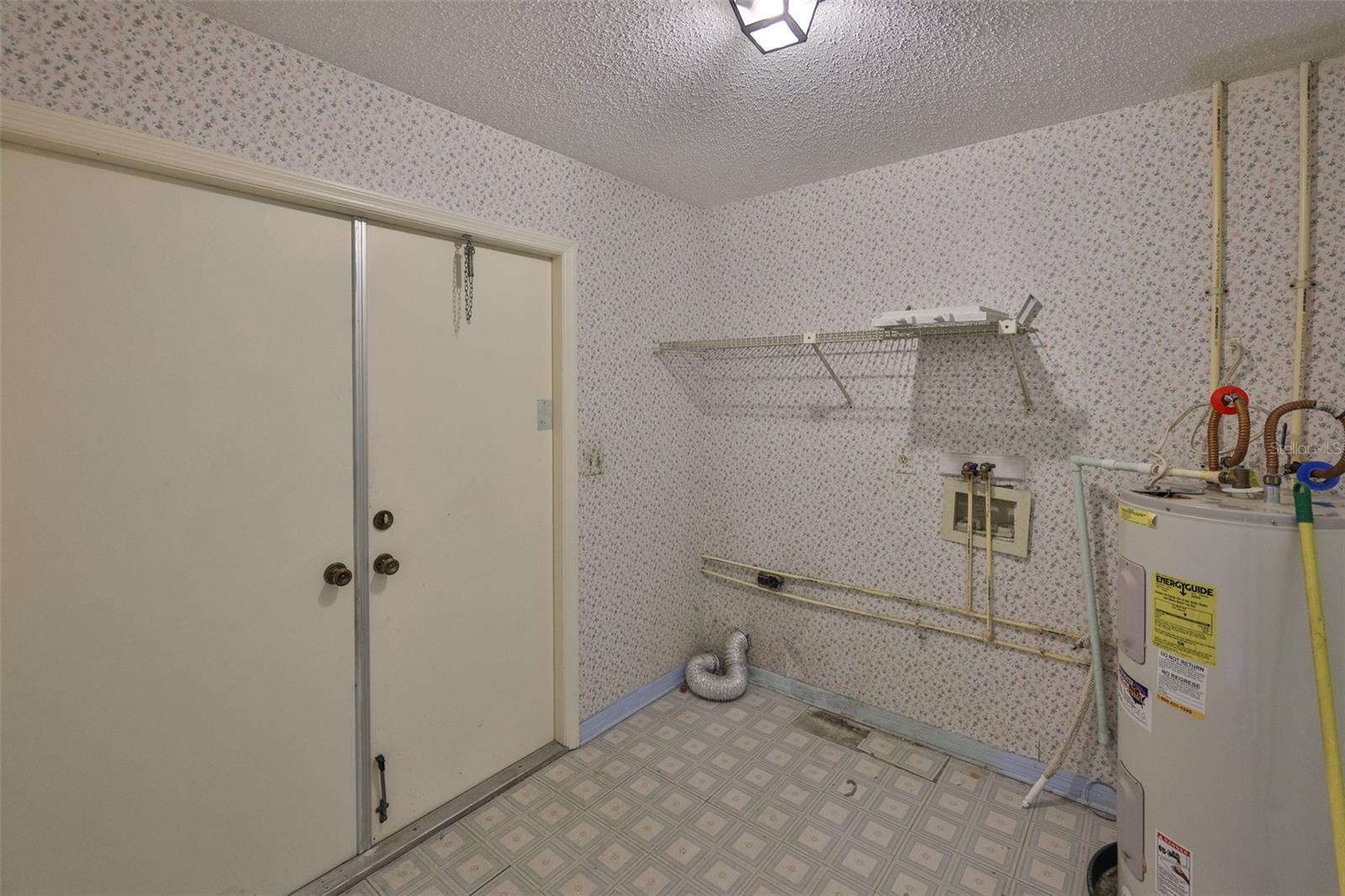 Large laundry room is inside with electrical hookups for washer and dryer.