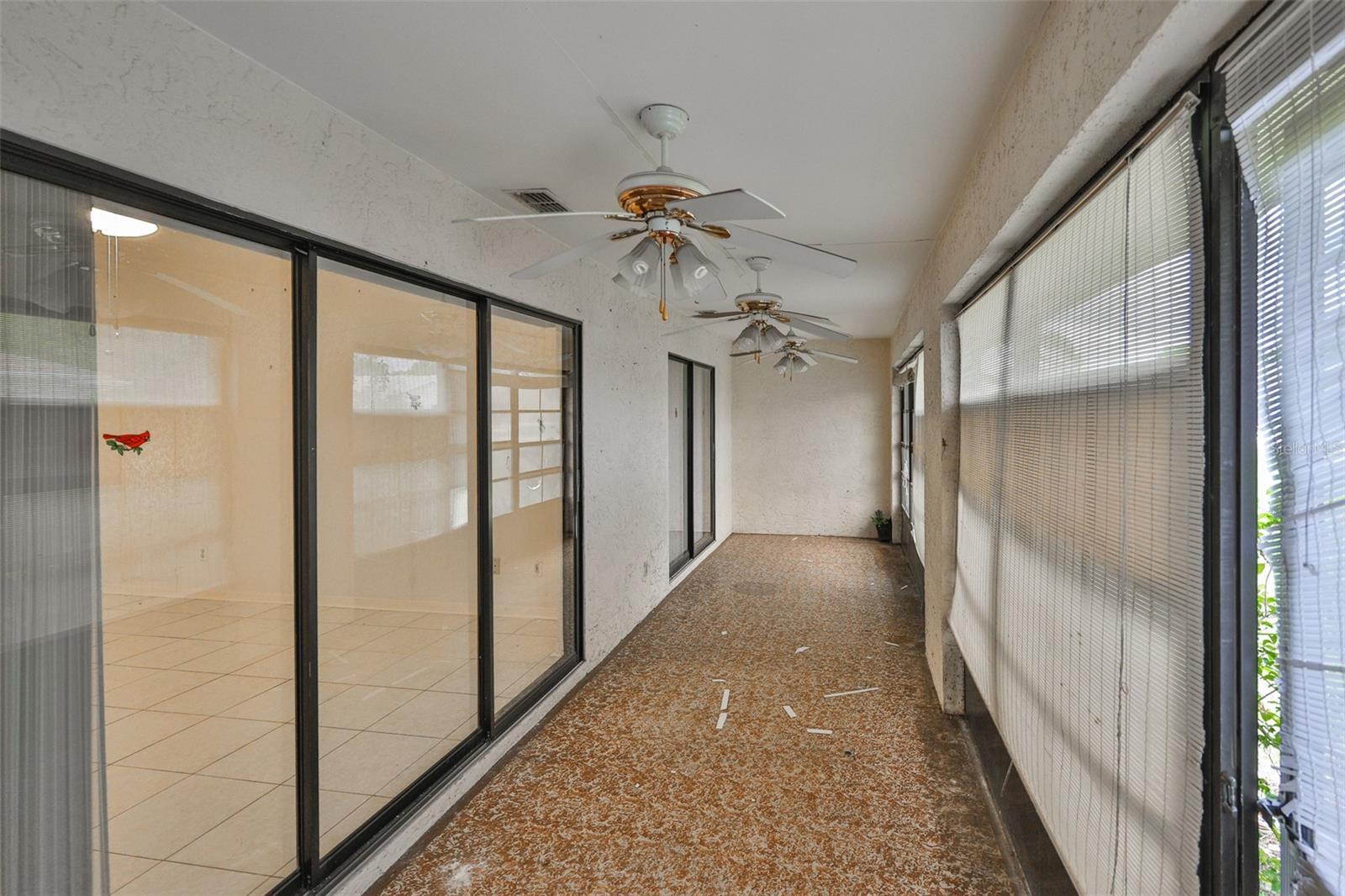 Lanai - Ceiling Fans and vinyl coatings and shades cover the screens.