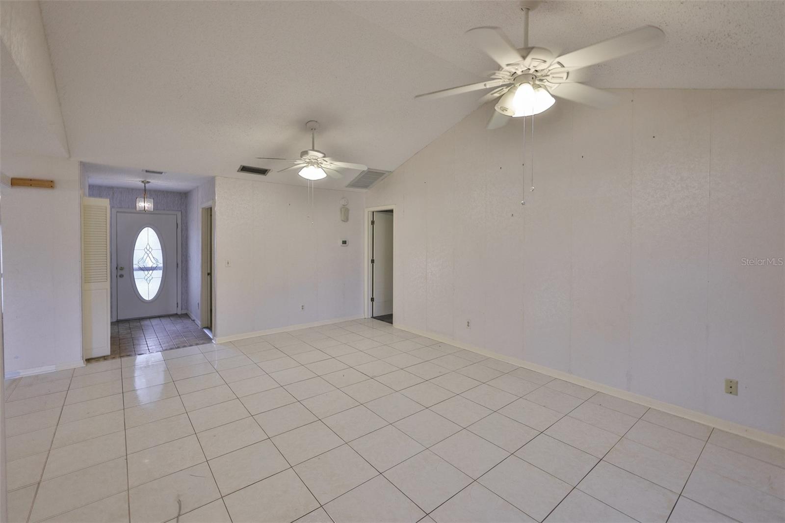 Great Room -As you walk into the home, notice the lead-glass door, closets and access to garage.