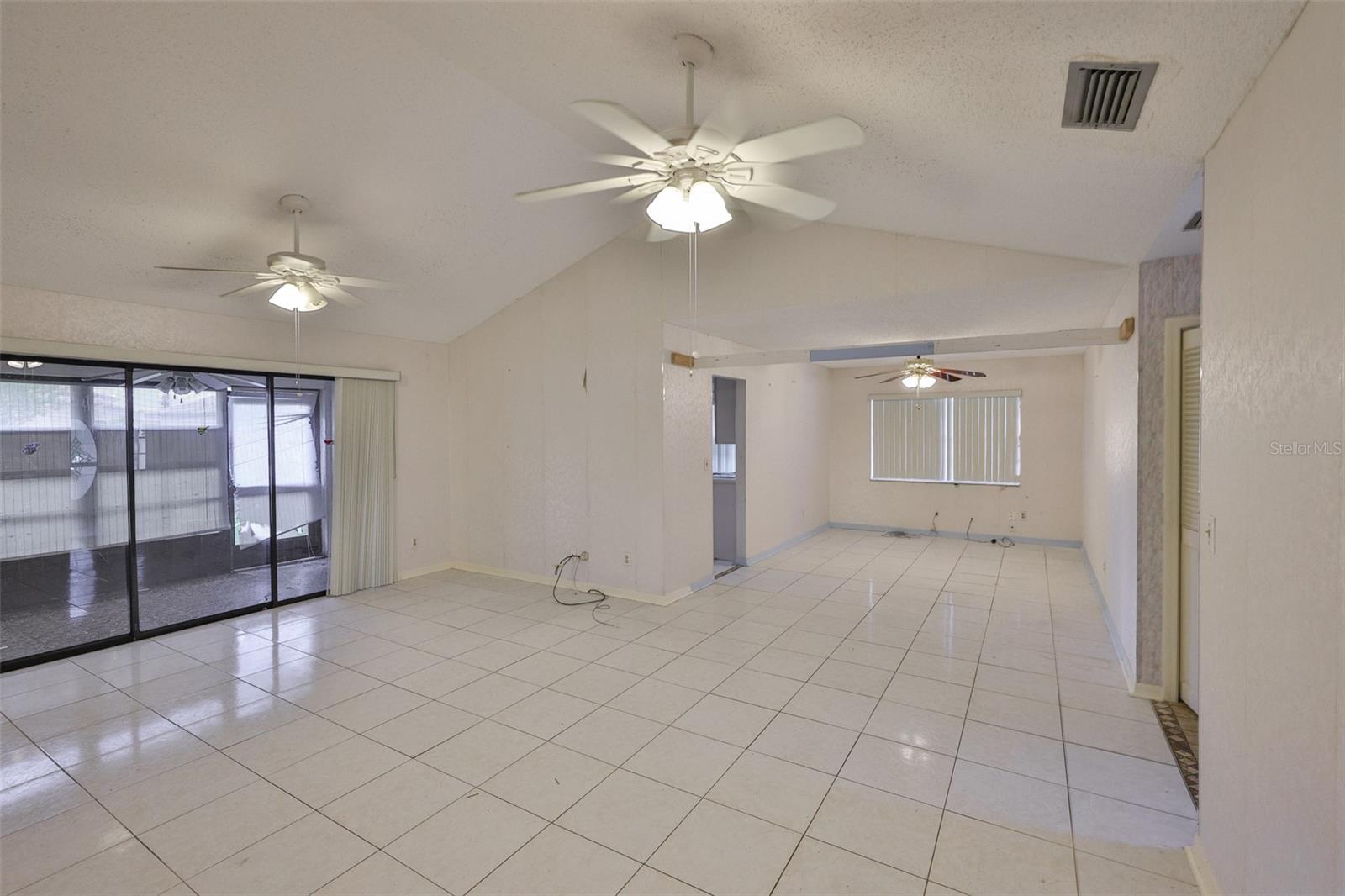 Great Room has vaulted ceilings and sliders onto the Florida room.