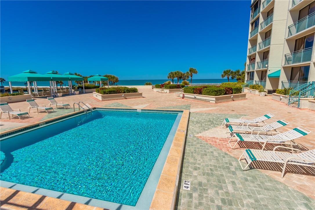 Poolside view with Deck Chairs and CABANAS looking at the Gulf of Mexico.