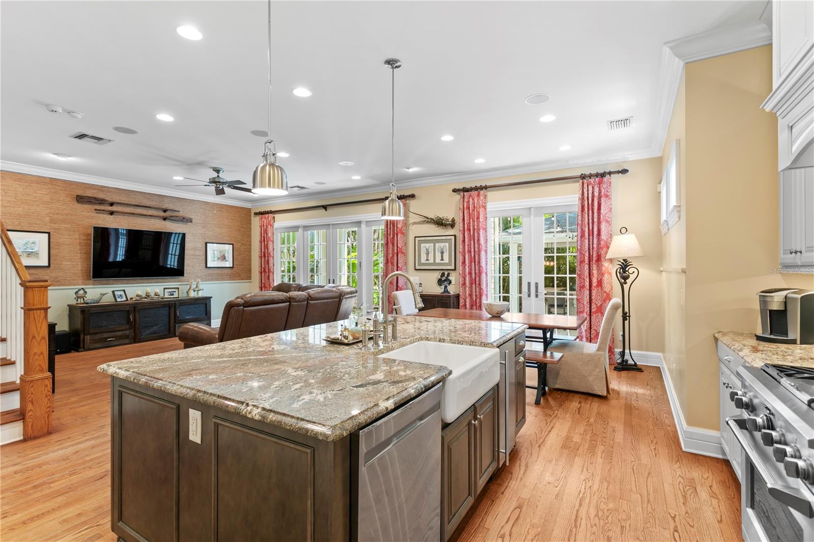 The spacious open-concept kitchen flows seamlessly into the large family room, with stunning French doors offering a beautiful view and direct access to the private backyard retreat.