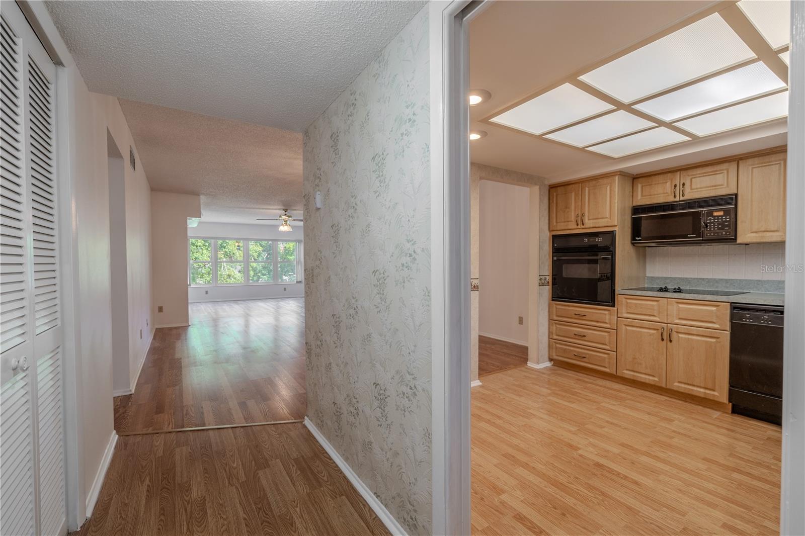 The foyer features a wood laminate flooring and a convenient coat closet.