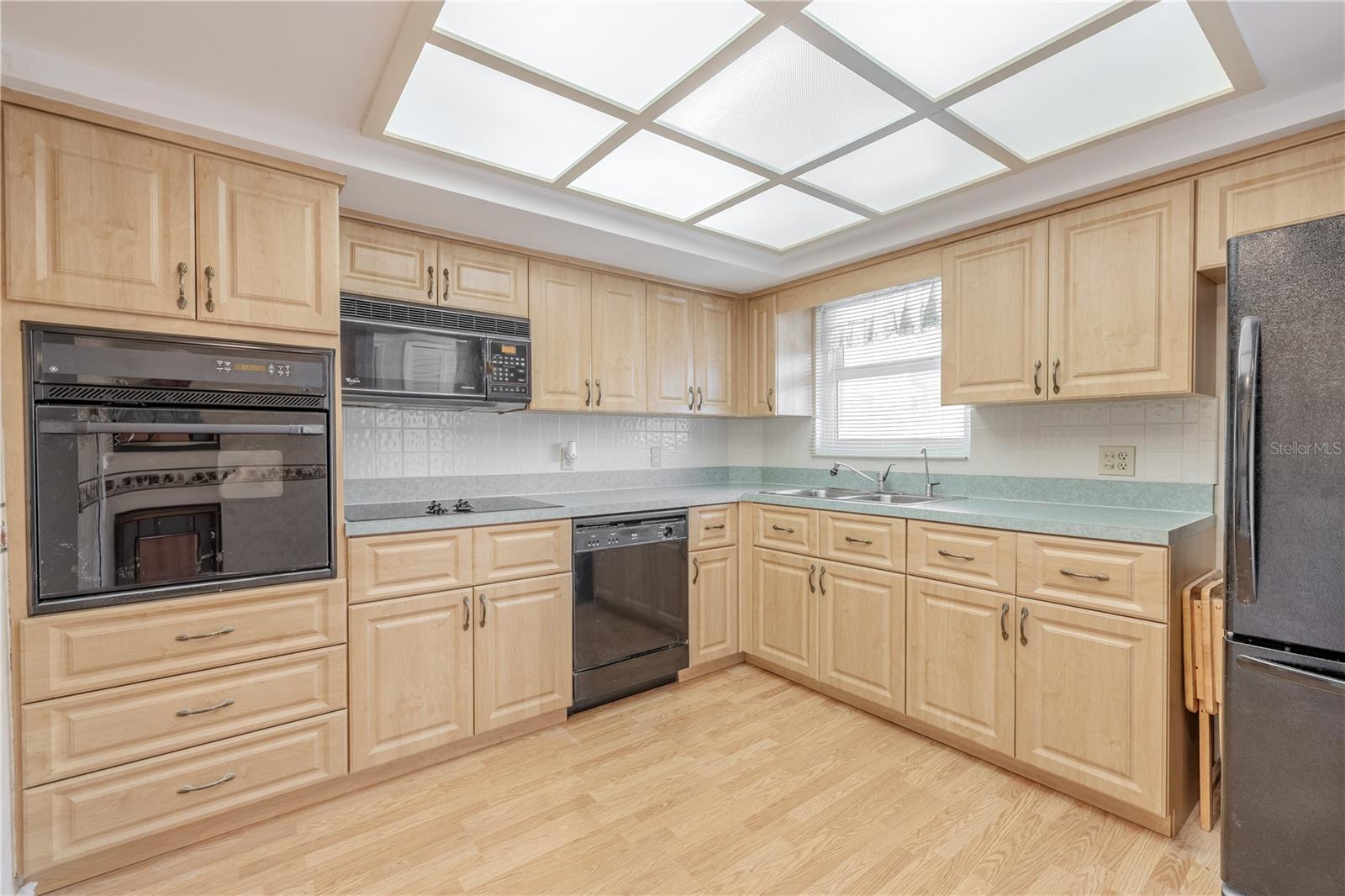 The kitchen features overhead lighting and laminate flooring.