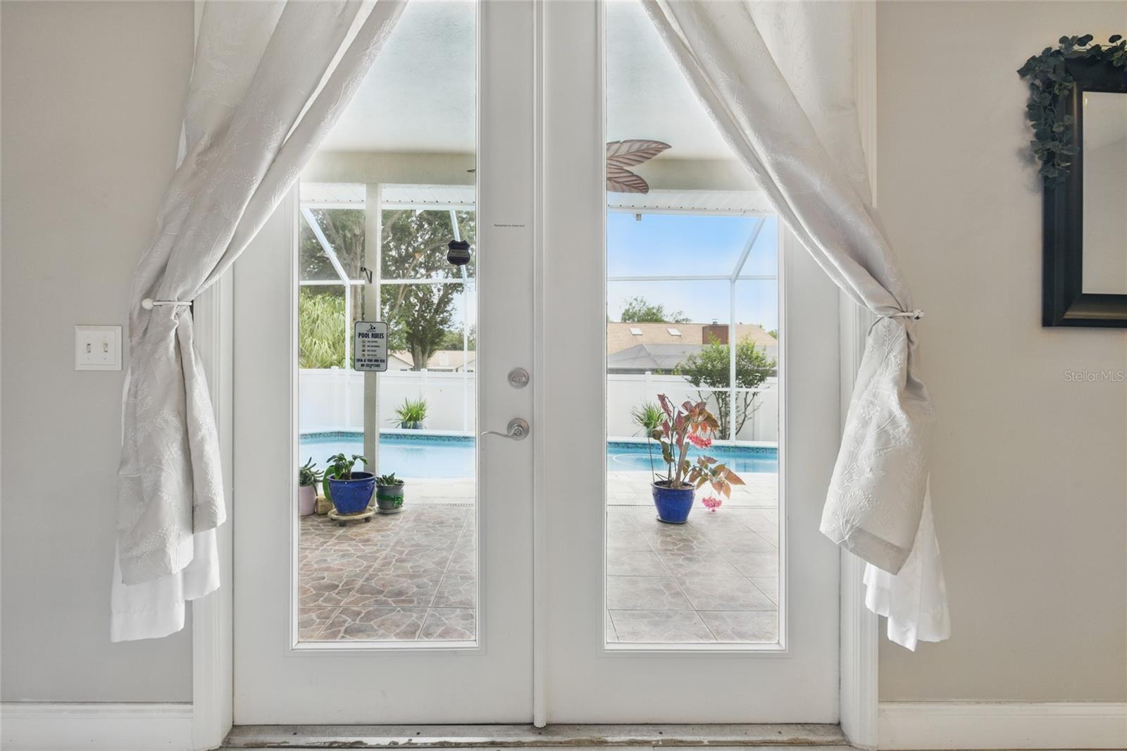 Double doors from the living area out to the pool