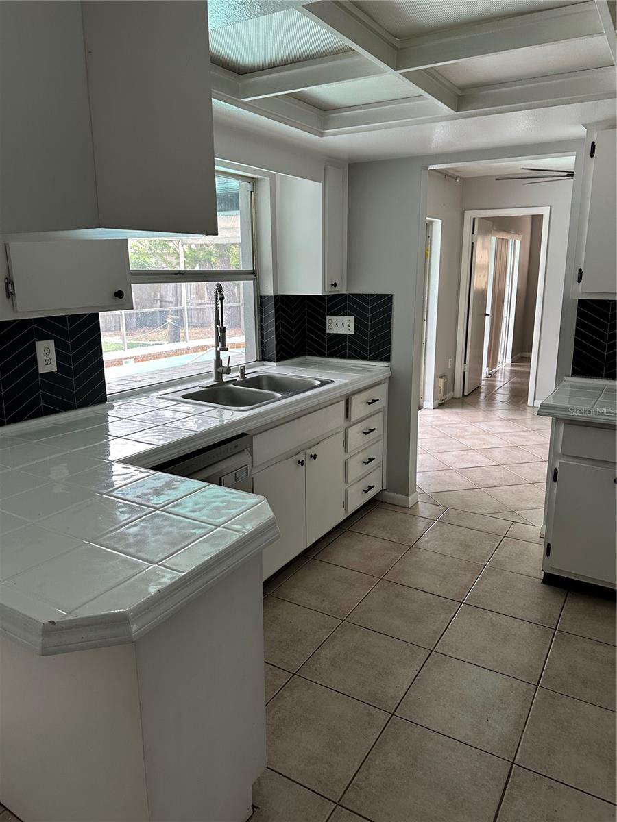 Kitchen with window and pass-through to the pool
