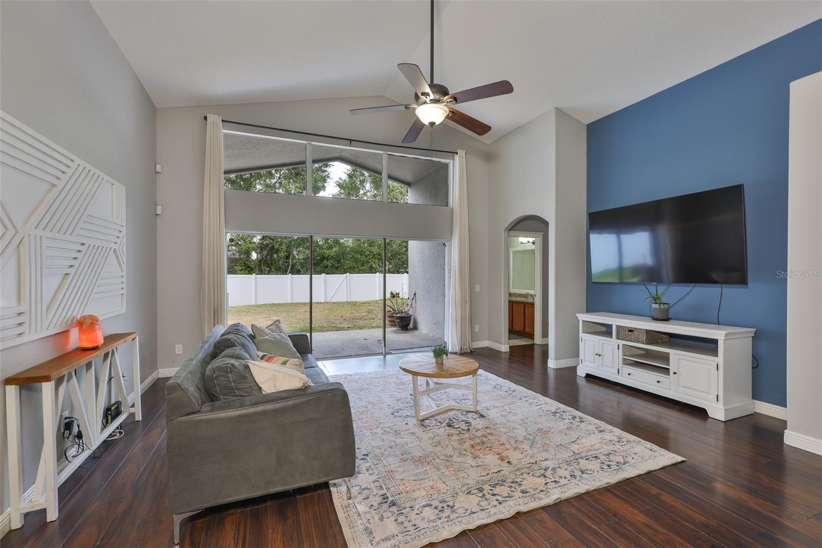 Large Sliders lead to the lanai and spacious backyard