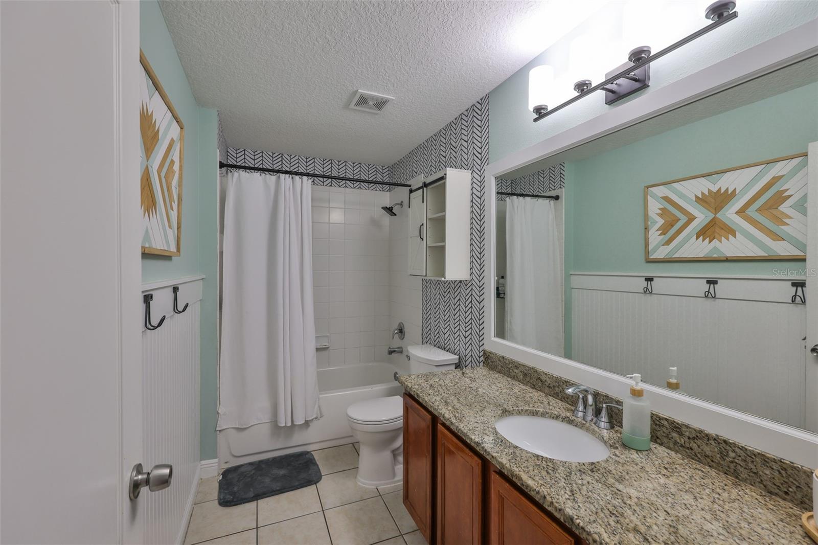 2nd bath with granite counter and beadboard with wall hooks