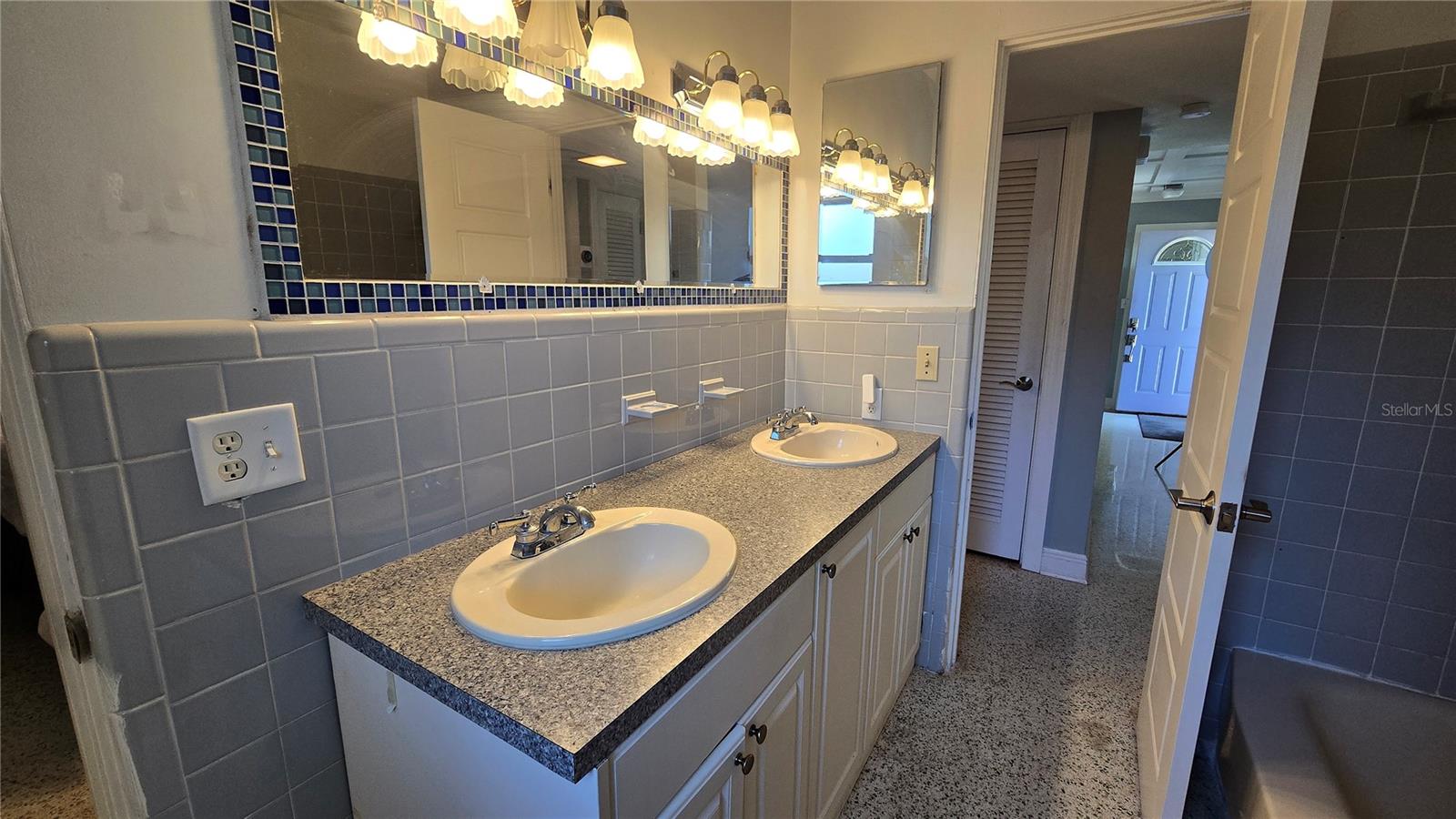 Bathroom with double sinks plus shower tub combo