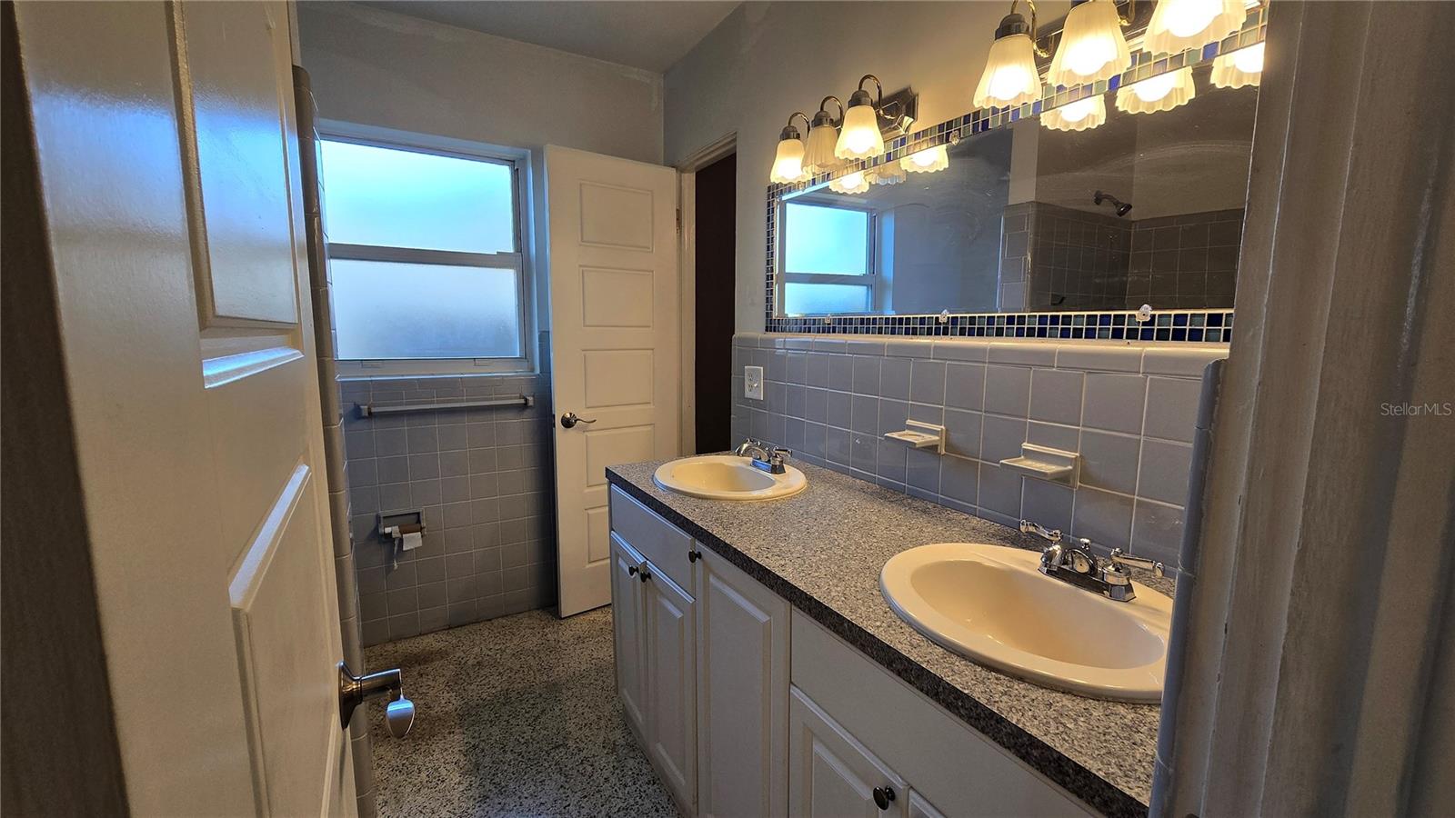 Jack & Jill style bathroom with access from both the hallway as well as the Primary Bedroom