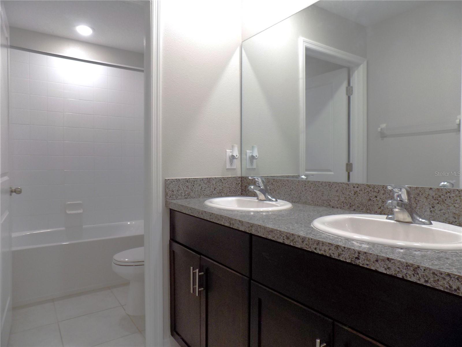 Upstairs full bath 3 with dual vanities and tub/shower combo