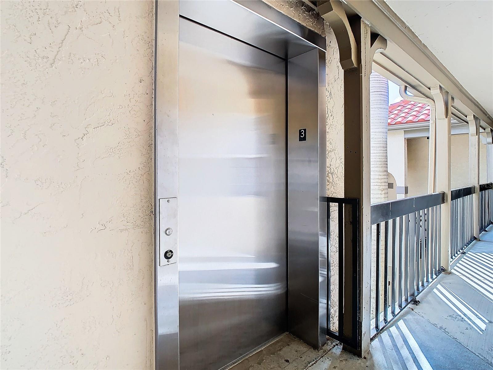 Building elevator located two doors down from unit.