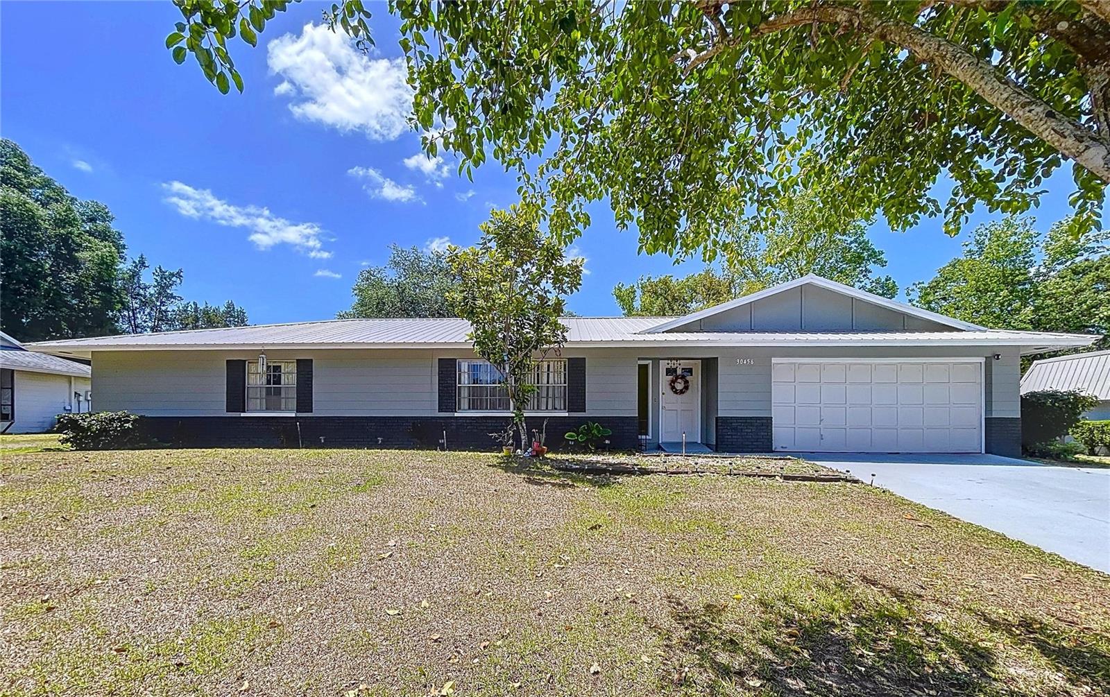 Beautiful 4 bedroom pool home with newer metal roof.