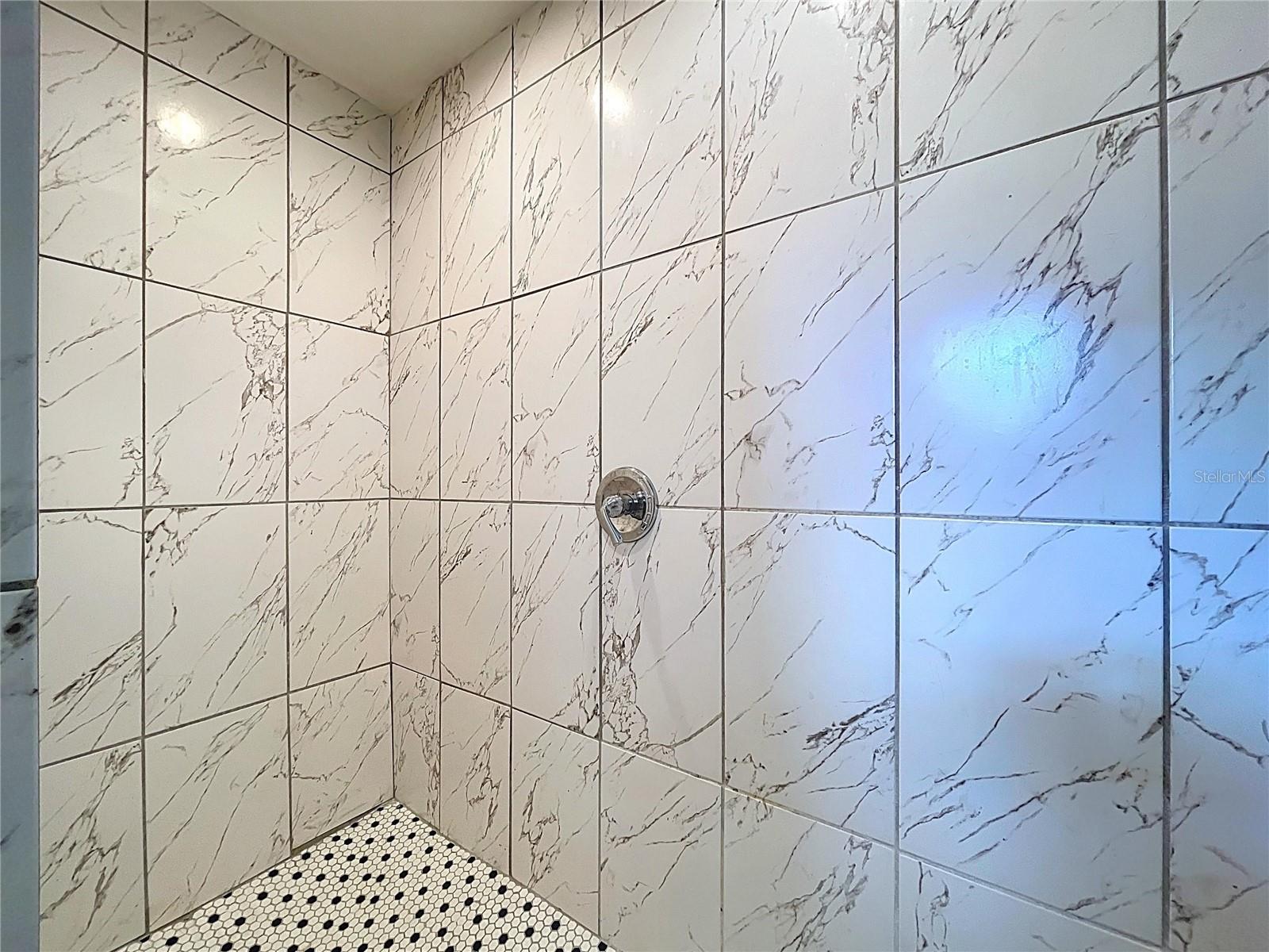 Primary shower features dual rain showerheads.