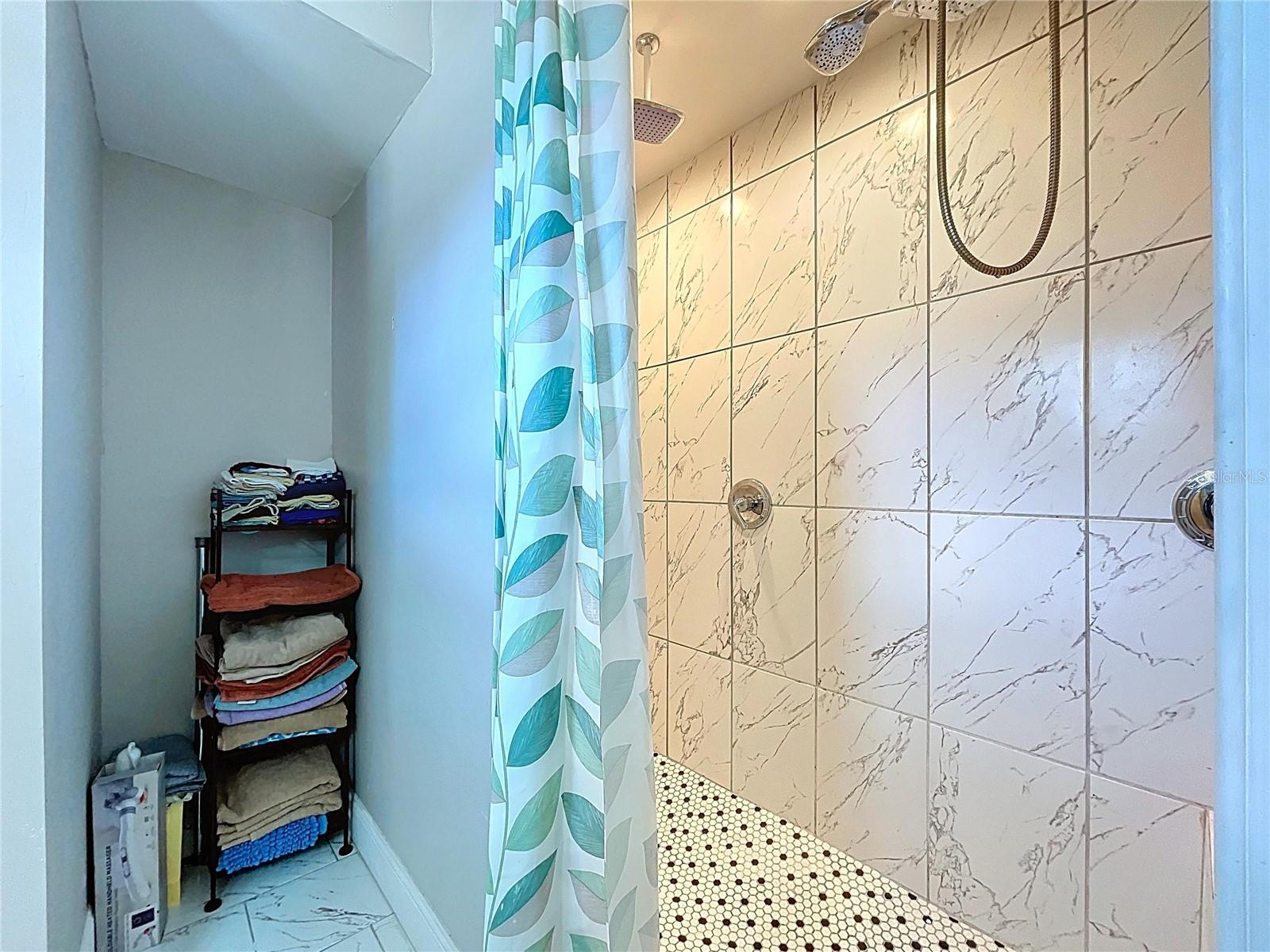 Primary shower features dual rain showerheads.