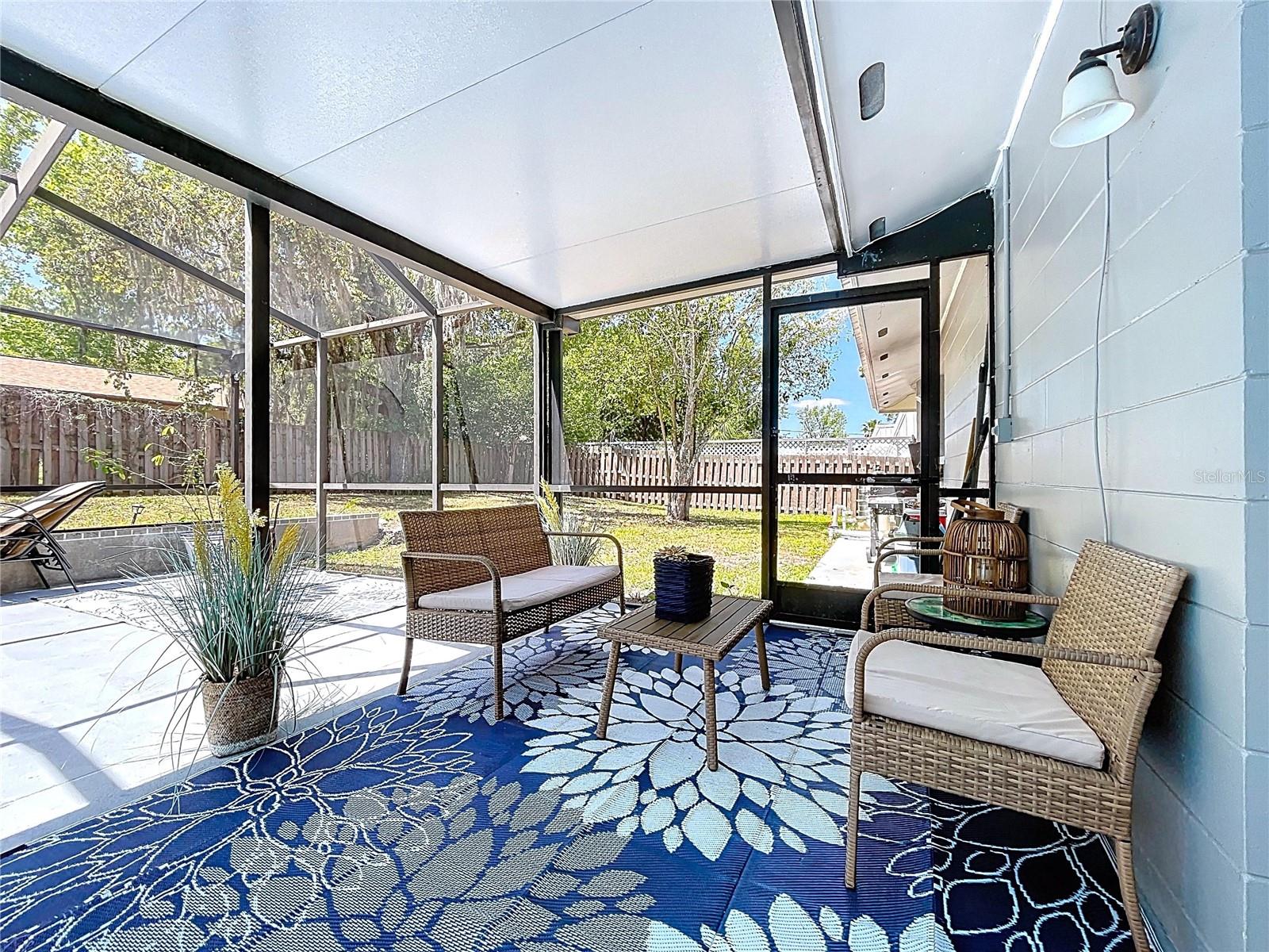 Covered patio provides shade for outdoor enjoyment and entertaining.