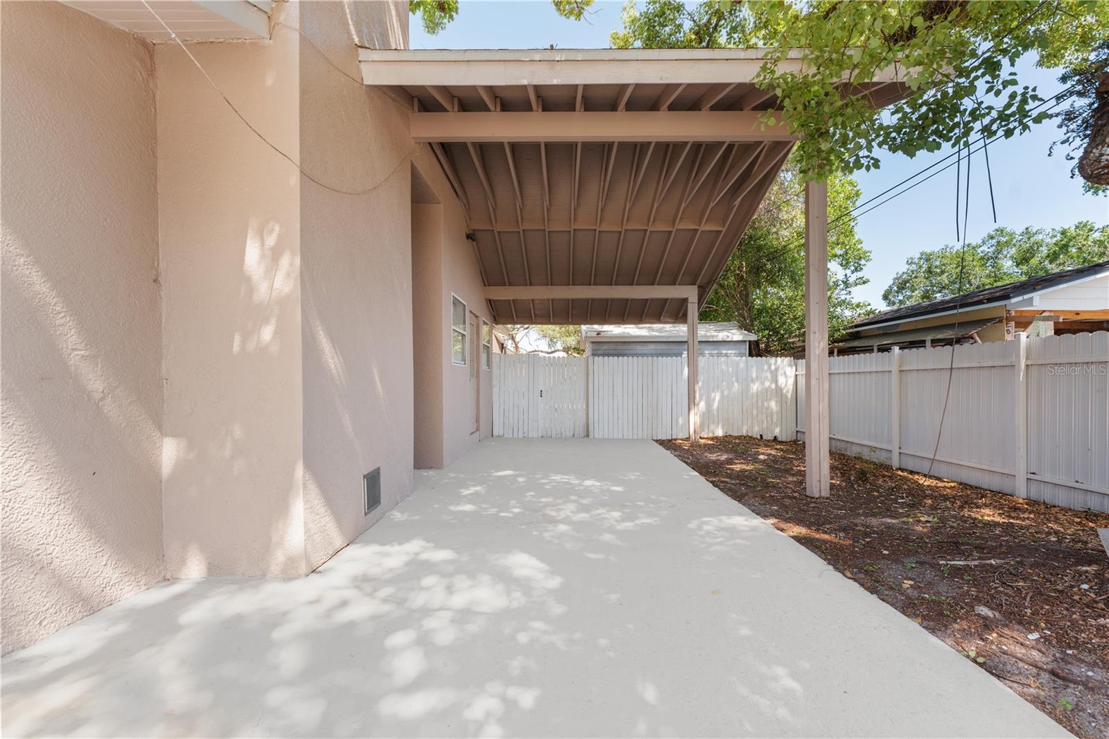 Additional covered parking on the right side of the house