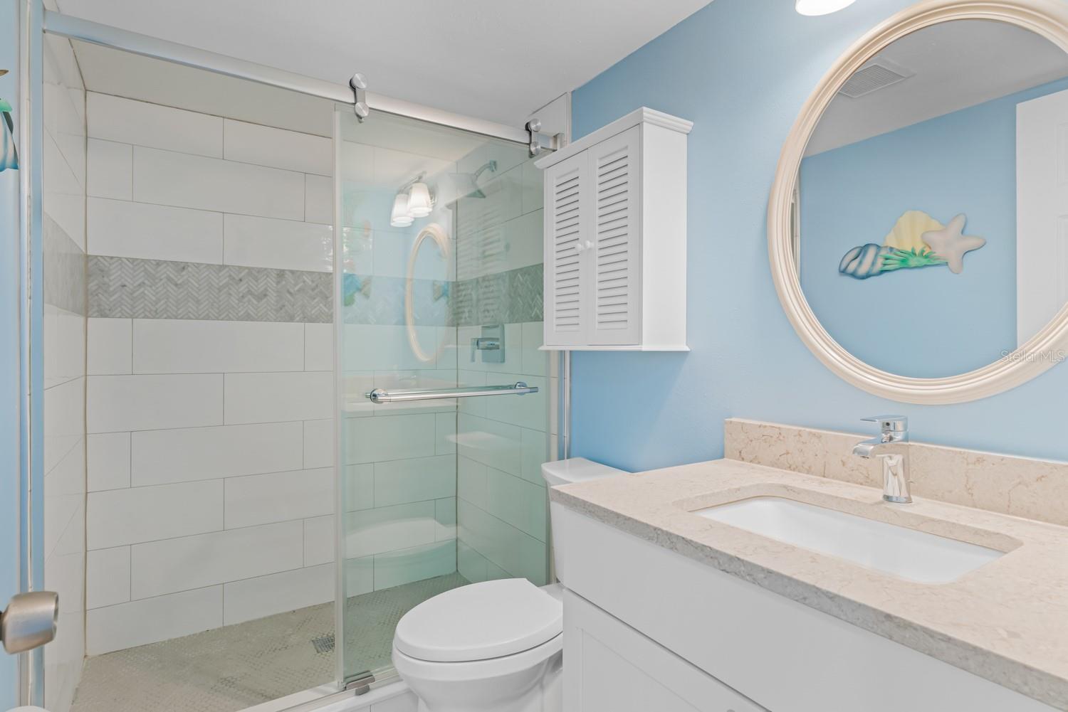 Bathroom 2 with walk-in shower and stone vanity
