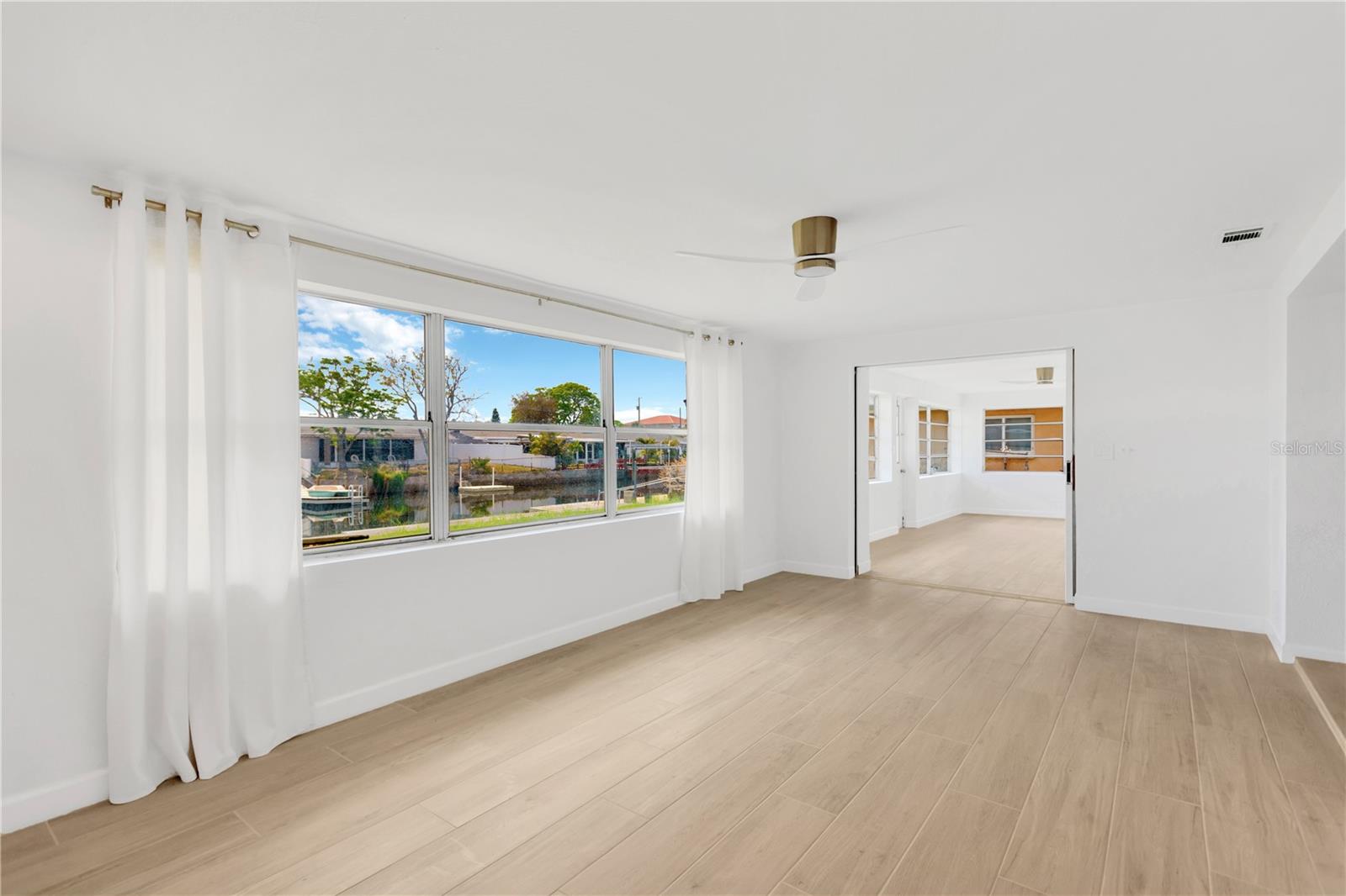 Family Room looking into expansive Bonus Room with pocket door