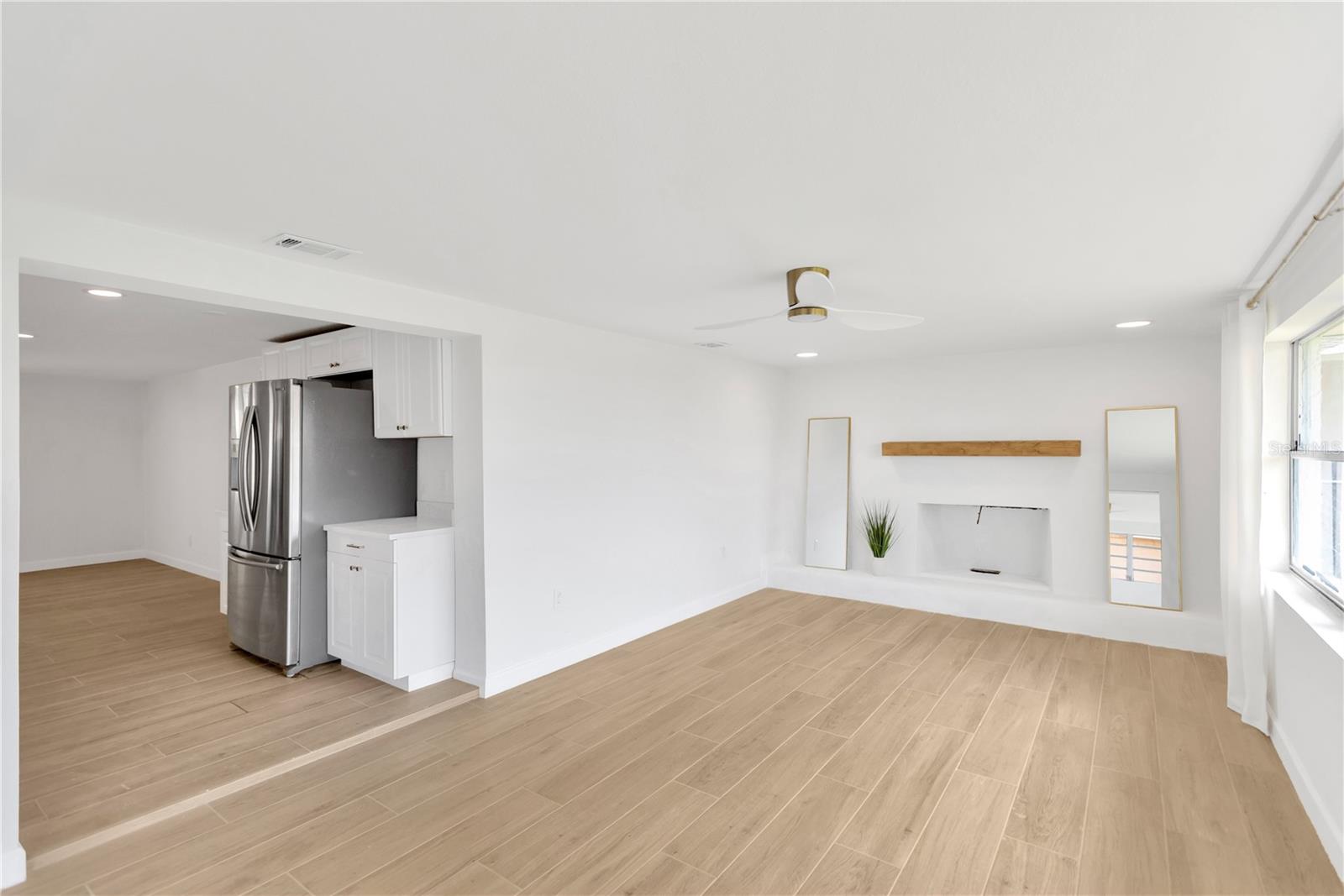 Step down into this Family Room with picturesque fireplace and windows galore.