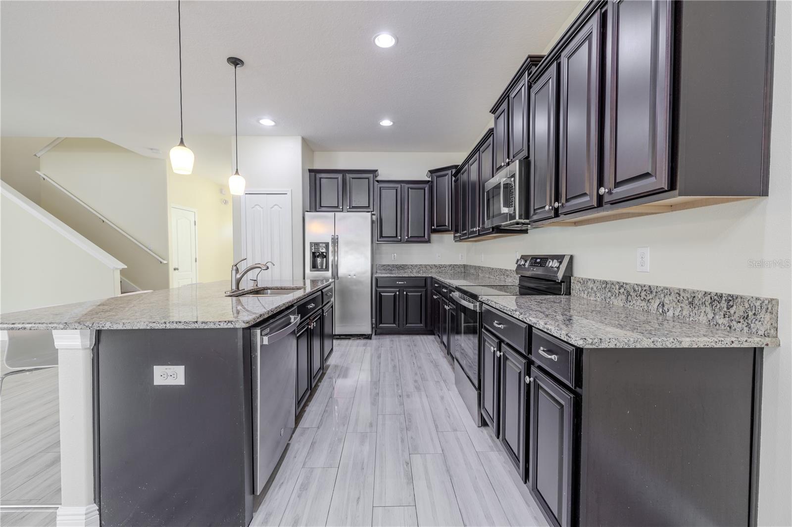 The kitchen features recessed lighting.