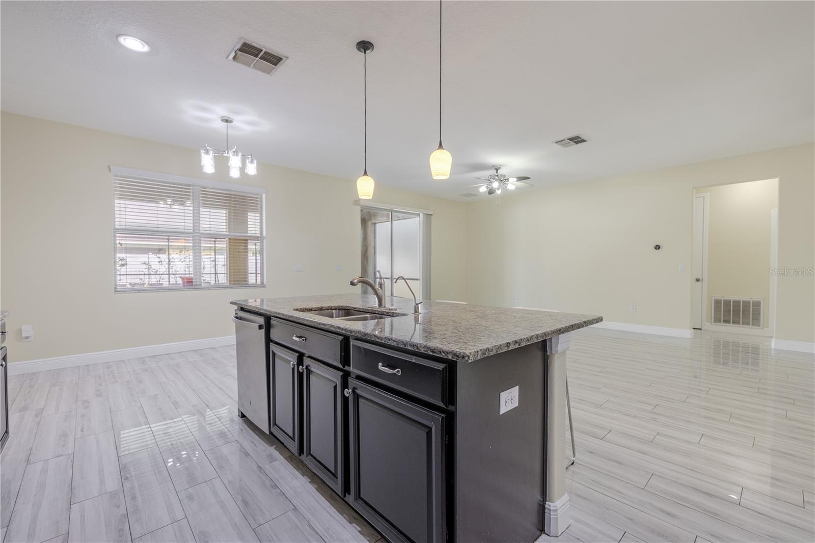 To the left of the kitchen island is a dinette area for your breakfast table.
