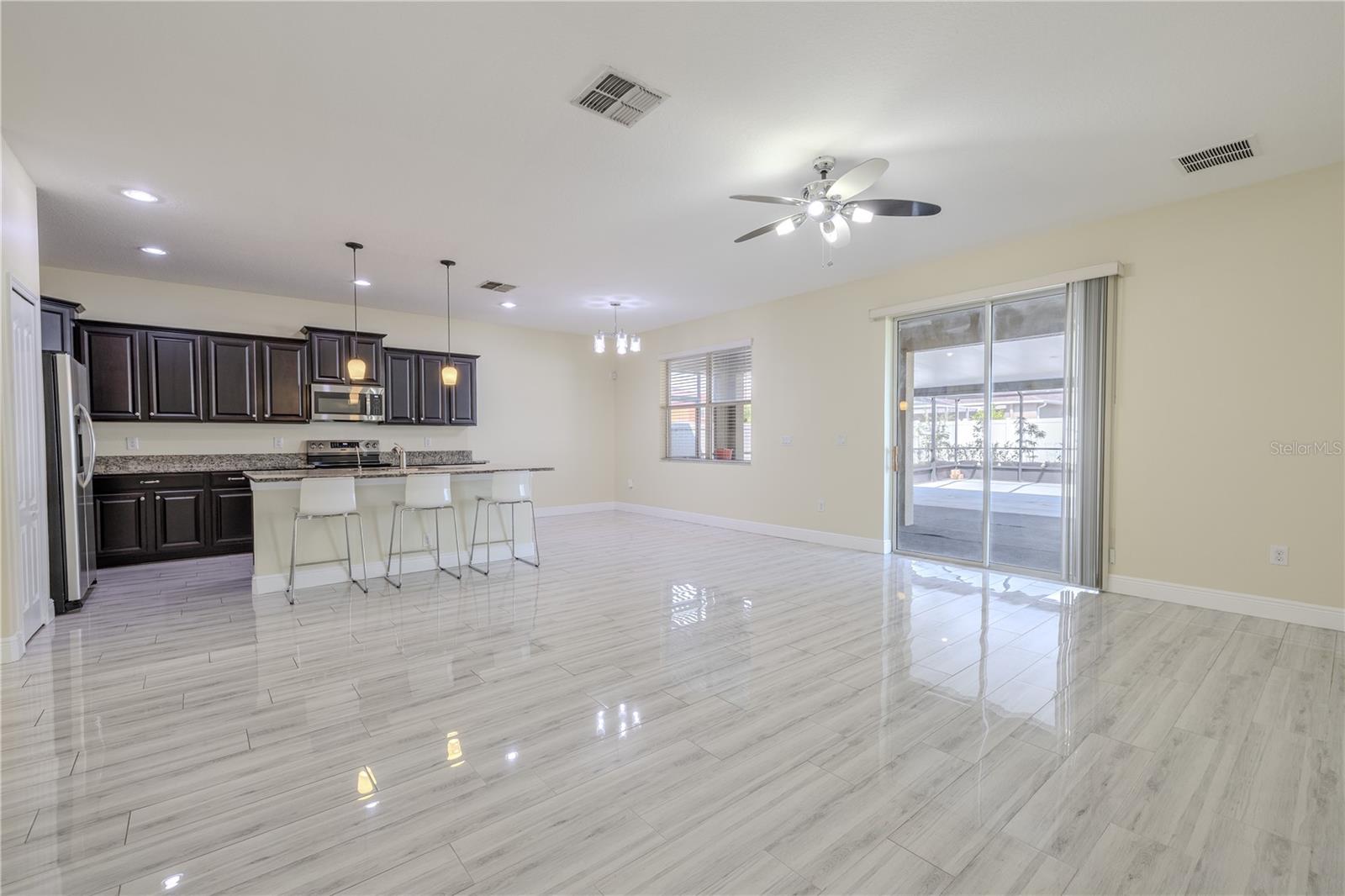 View of kitchen and dinette from family room. Family room has sliding glass doors to the lanai.