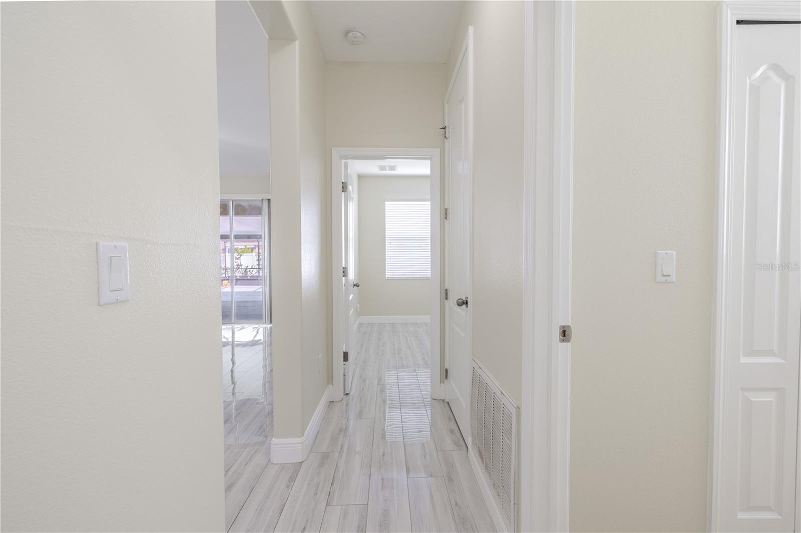 Hallway to 4th bedroom, 3rd bathroom and laundry room