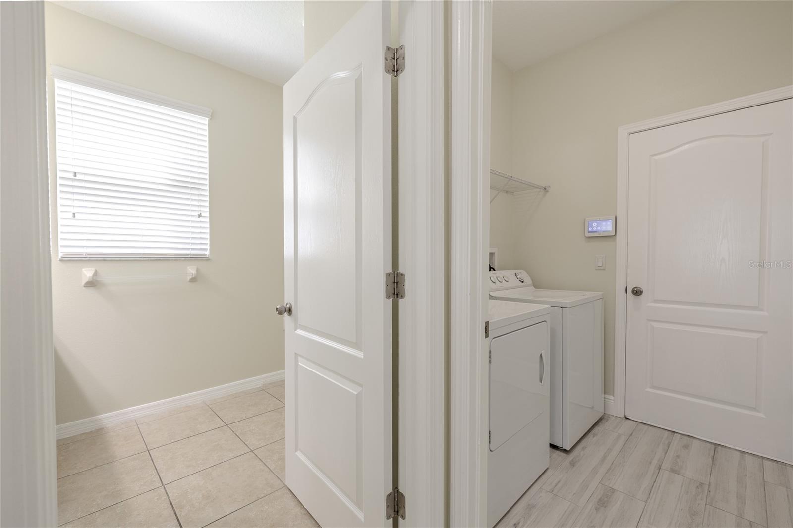 Laundry room has an entrance to the garage.