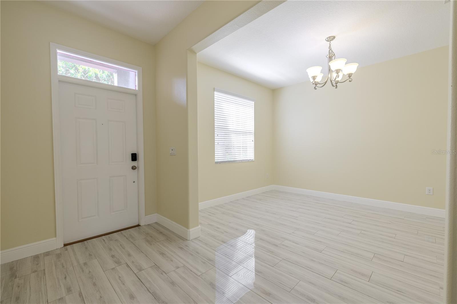 Enter through the foyer to stunning porcelain plank tiles throughout the first floor.