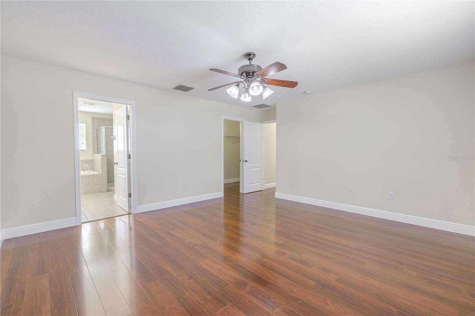 Primary bedroom features an ensuite bath and 2 walk-in closets.