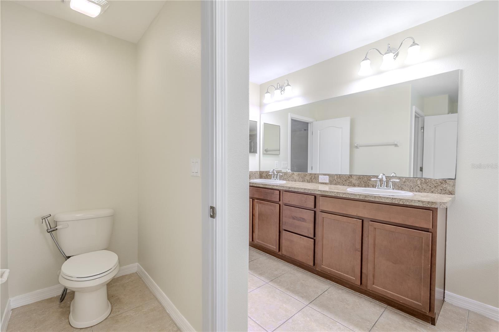 Primary bathroom features a private water closet