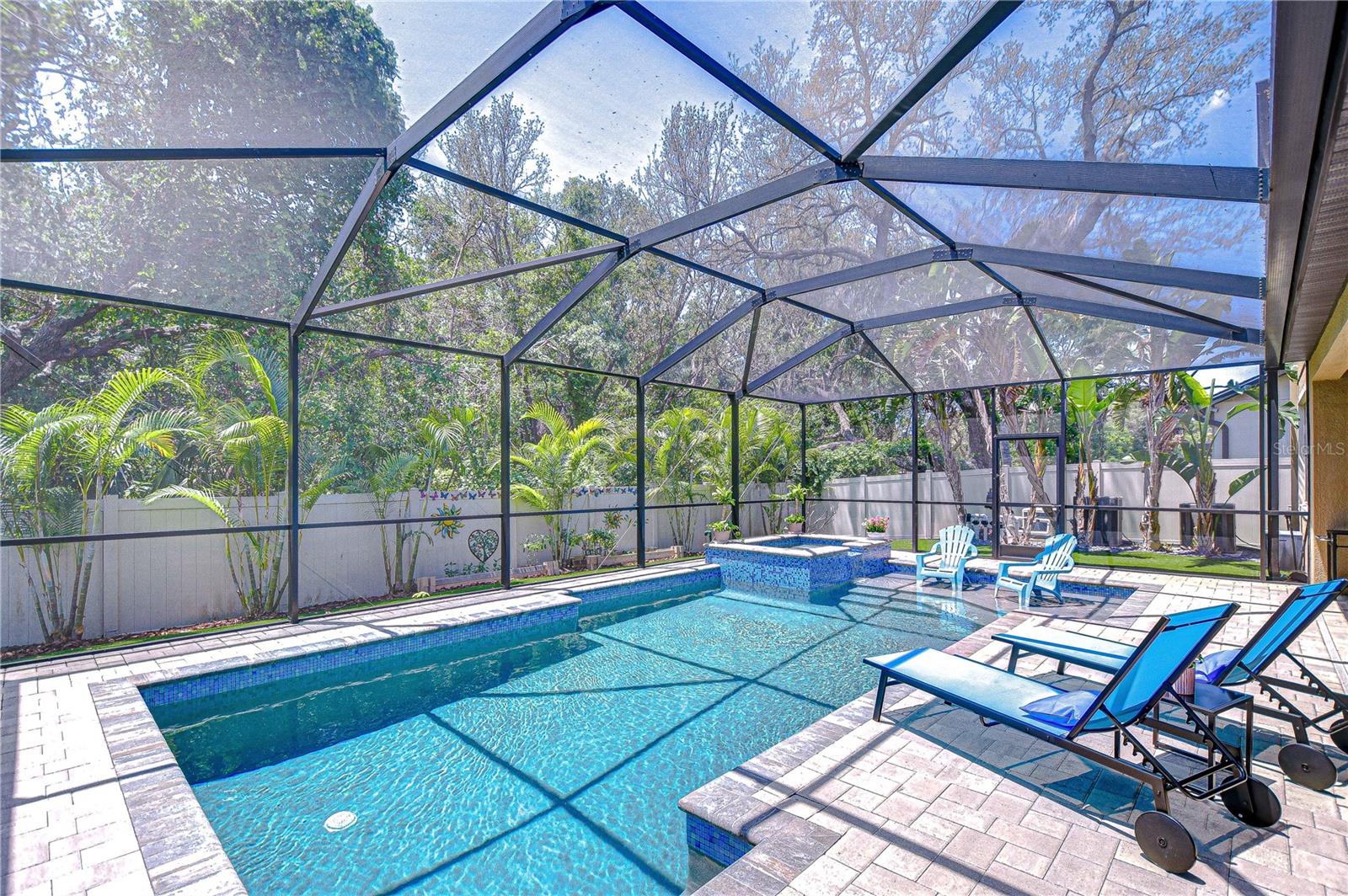 Dive into paradise in this beautiful screened-in pool oasis!