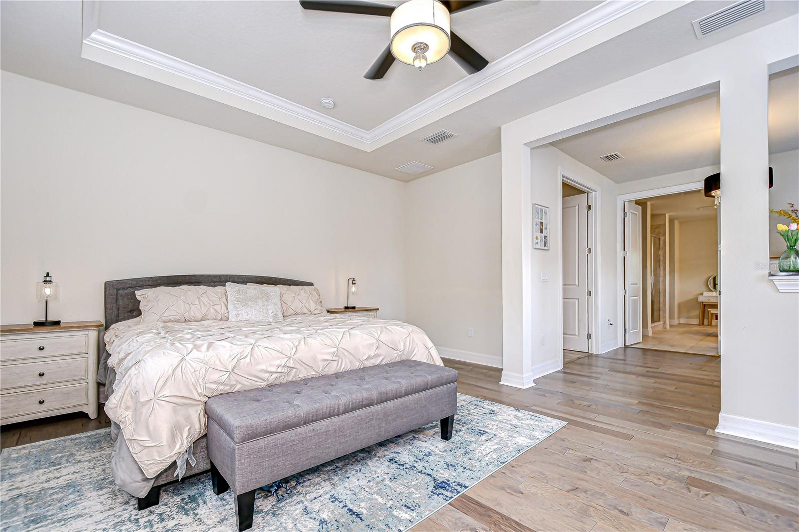Tranquil primary bedroom retreat with elegant tray ceiling!